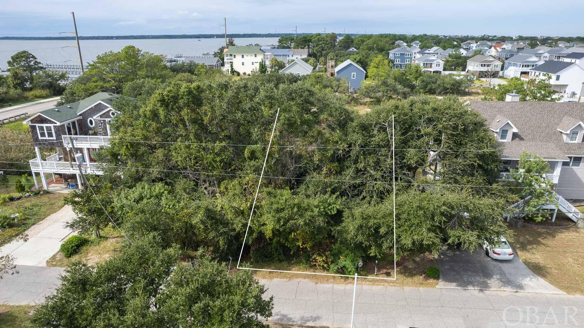 Build and own your own OBX cottage! This 50 x 100 lot is close to all the Outer Banks has to offer. Located steps from Bay Drive and the multi-use path, you may even catch a sliver of sound view from your new porch. The lot has undergone all of the wetland mitigation and is ready for your vision! Please call your agent to discuss the mitigation process and don't miss out on this opportunity!