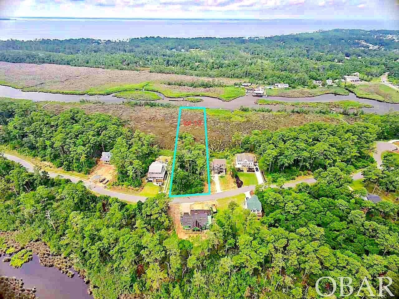 Rare Spacious acreage with deep water access in Kill devil Hills Sunrise Crossing! Soundview / Deep Water Canalfront Harborview lot.  Private waterfront homesite w/ private dock potential located in newly developed Kill Devil Hills -OBX soundfront community.  Beautiful Sound, Harbor, and Marsh views with deep water canal frontage for private dock and direct sound/ocean access.  Largest waterfront lowest price per sqft/waterfront acreage!  Build your dream home on the waterfront, 2nd home or vacation investment property.  Utilities are run thru community already and path to private dock waterfront access located by sign in front of lot. Great backside view from community dock on right as you enter community.  Centrally located between Nags Head and Kitty Hawk, close to the Sound/Ocean access, Oregon inlet, Sound, Beach, Marinas, Restaurants, and all the Outer Banks NC has to offer!