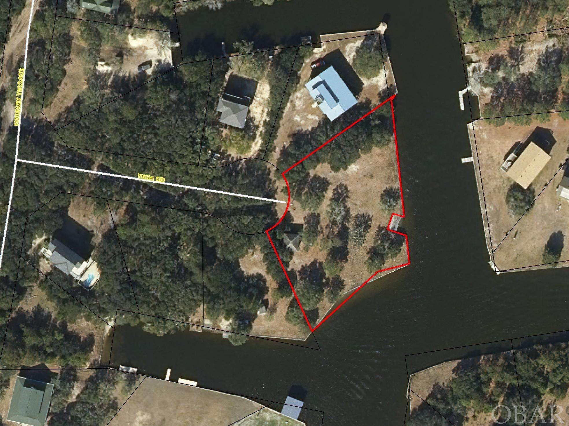 Check out this oversized canalfront lot with easy access to the Currituck Sound. This used to be two adjoining lots that have been recombined into one GIANT lot with approximately 370 feet of water frontage already bulkheaded with a boat ramp for getting your toys in & out of the water that much easier. There is a  a recent survey and Perc Test already on file for 2 different locations. Enjoy life with the Corolla Wild Horses during the day and watching the sun setting over the sound at night.