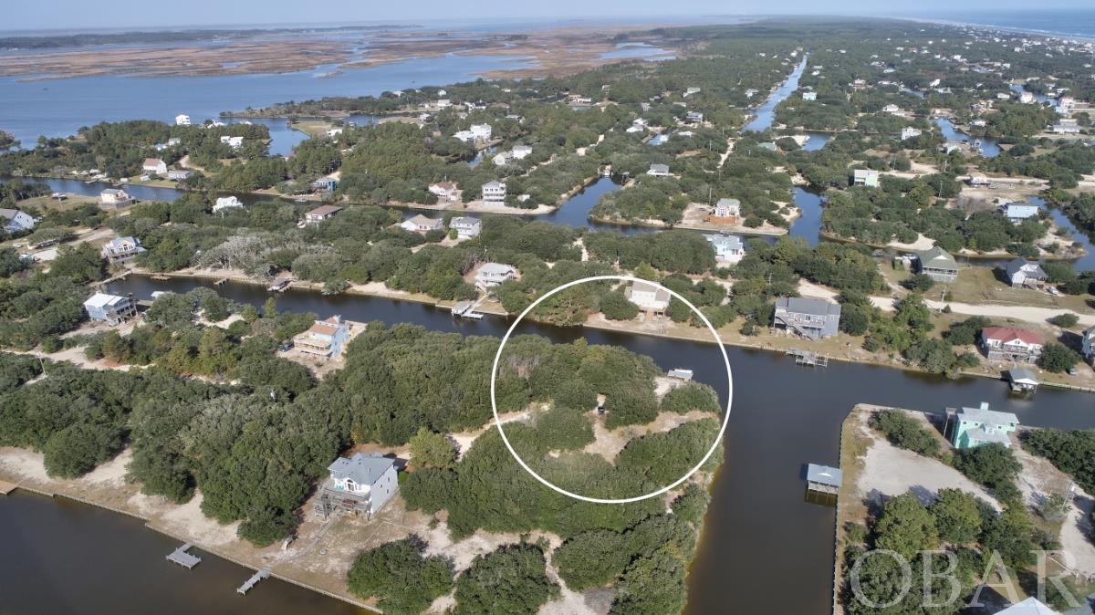Is Carova Beach calling your name? These 170 feet of waterfrontage can be yours! This lot has a lot to offer. It is located in a quiet cul-de-sac, just minutes from the Currituck Sound. It already has a dock, so bring your boat and enjoy. Do you like to fish, kayak or paddleboard? Do you like to be away from the hassle and bustle? Then this is the perfect spot. You would also be a short drive from the beach, where you can be playing in the waves or surfing. This is a truly beautiful place and the horses that roam free on the beach and in the canals are just an icing on the cake!