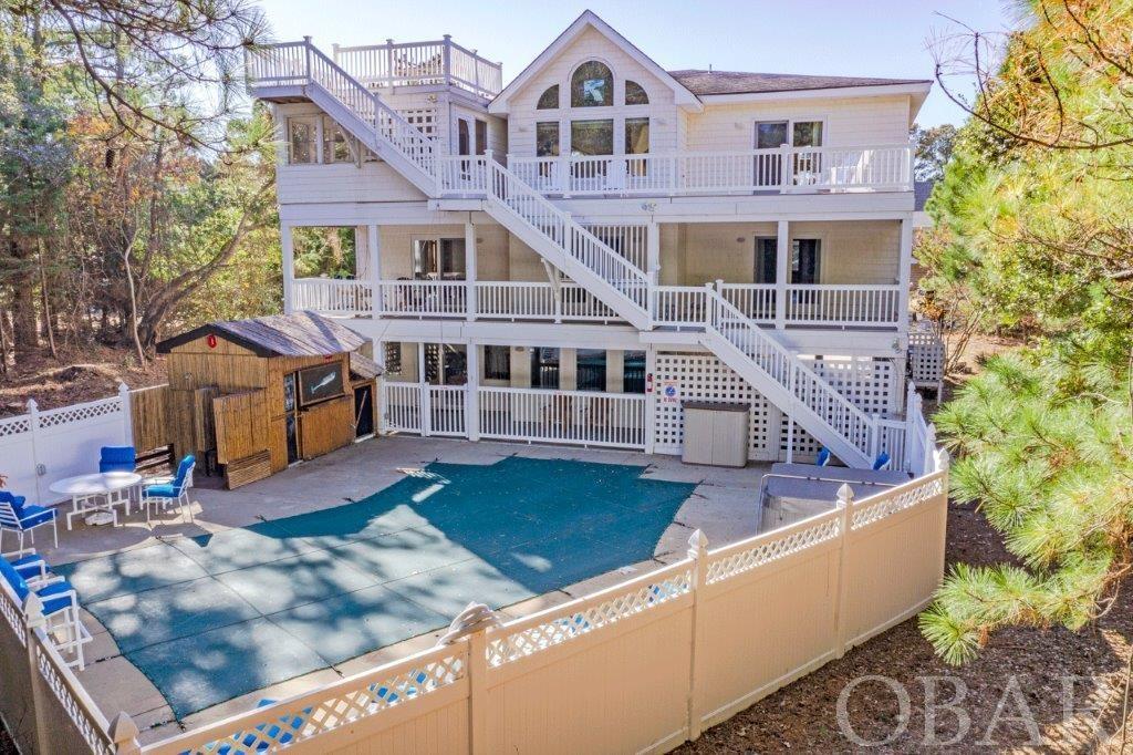 INCREDIBLE VALUE! Outer Banks Parade of Homes AWARD WINNER! ...  ARCHITECTURALLY STUNNING DESIGN & PROFESSIONALLY DECORATED! * WELL-BUILT OVER 5000 SF HOME W/ 2X6 Wall Construction *** ELEVATOR TO ALL 3 LEVELS! 4 Gas Fireplaces! * "Large Heated "Very" Private POOL" * CABANA BAR W/ REFRIGERATION & 3 Inch Oak Bar Top * HUGE GAME ROOM * You will FALL IN LOVE with this Home and Location in SOUTHERN SHORES * Perfect for Weekly Vacation Rental Home * Home would also make a wonderful SECOND HOME / PRIMARY RESIDENCE *** This Home would be a Great Place to share with family & Friends to Enjoy the Beach * HIGH ELEVATION "X" FLOOD ZONE (NO FLOOD INSURANCE REQUIRED) Located in the Dunes w/ EASY ACCESS TO THE BEACH *** Features include: Two Story Foyer, Grand Oak Staircase, Kitchen w/ Granite Counters, Center island Cook Station, 4-Person Breakfast Bar ... Opens to an Incredibly Spacious Great Room w/ Cathedral Ceilings, Ceiling Fans, Oak Flooring, Gas Fireplace, Guest Powder Room, ELEVATOR, Incredible number of Windows for Natural Lighting, Spacious Screened Porch, Entrance to "Very Large" MAIN En-Suite Bedroom w/ GAS FIREPACE & Full Bath Featuring Green Tile Flooring which will leave you feeling like you're swimming in the Ocean ... Walk-in Closet ... Deep Jetted Tub, Double Vanity, Private Water Closet, Walk-in Tiled Shower ... You will Love it! *** Easy access from Great Room to Large Screened Porch w/ Ceiling Fan Overlooks the Pool Area ... Nice Deck with Trex Decking & Vinyl Railings ... Stair Up to ROOF TOP DECK - Great for Private Sunbathing * Seller advises 40yr Roof shingles *** Rear Deck Stairs Travel from Roof Top Deck all the way down to the Pool Deck for easy access *** LEVEL 2 FEATURES: ELEVATOR ... 4 Bedrooms - 2 of which are En-Suite Bedrooms, and one is another Main En-Suite which is a near replica of the one on Level 3 above it - this one also includes a GAS FIREPLACE both with different finishes * Laundry in Hallway on this level * LEVEL 1 FEATURES: ELEVATOR ... Storage Rooms, Guest Bedroom with connecting Full Bath shared with the Wonderfully (Very Large) Designed FAMILY ROOM w/ Gas Fireplace & Entertainment Center & Game Room w/ Billiards Table * When arriving in Summer all you will want to do is jump into the Pool to Cool Off or Sit Poolside to catch some rays! ... Or maybe sit at the Classic Cabana Tiki Bar to enjoy a cool drink & a little Shade * POOL is VERY PRIVATE * This Home will be a treat to see and an even bigger delight to Own and Enjoy! * Walk to Beach at E Dogwood Trail w/ Lifeguard in Summer ... or 5 Min Drive to the Hillcrest (Main) Beach Access (APPRX. 60 Parking spaces) w/ concrete walkway to Beach Access, Open Trellis Showers, Volleyball Court, Gazebo Deck, Dune Deck, "wheelchair ramp accessible", Lifeguard in Summer ... Southern Shores is Wonderful to Experience in Summer and even more so in the Off Season! * Multiple Boat Marinas, 2 SOUNDFRONT BEACH PARKS, Revitalized Dune area Basketball Court, Playpark * Outdoor Community Tennis Courts * Tennis & Boat Slips are additional and subj to availability * Not required to have a boat club membership to access the Boat Ramp ... The Southern Shores Civic Association (SSCA) is optional, but the cost is only $65 per year so everyone joins * Sidewalk through entire Town along Duck Road - Great for Biking & Running *** Don't miss shopping & restaurants, the Duck Town Green, & the DUCK SOUNDFRONT BOARDWALK! Close to WRIGHT MEMORIAL BRIDGE *** The Outer Banks is Filled w/ Exciting things to do and see ... The Ocean, Lighthouses, Wright Brothers Monument, Carolina Blue Skies, Amazing Sunsets & More! * Added Features: Tommy Bahama Furniture, $50K window treatments, Cypress Wood / Trim with 36-inch solid wood doors throughout, New in 2021 = 7-person Hot Tub, New 2020 Pool Liner * New 2022 75-gallon Gas Water Heater *** https://www.southernshores.com/outer-banks-rentals/0359-best-kept-secret * 2022 Owner Rental Income $87,166 * Live the Dream ... COME SEE!