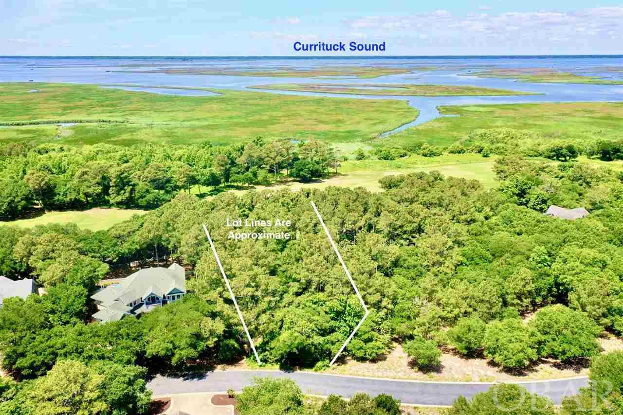 Beautiful lot tucked away in a private cul-de-sac setting perfect for your year-round homesite or rental investment property! Located on the 17th fairway of renowned Rees Jones Golf Course you'll have sensational views of sunset skies, the Currituck Sound and nature abound! Beautiful Live Oak trees, great elevation in X Flood Zone! One of the seller's favorite features other than privacy and peacefulness of the cul-de-sac is the location and protection from the area's NE winds! Enjoy all of the spectacular amenities TCC has to offer including 3 Community pools, a fitness center open 7 days a week, tennis & pickle ball courts, basketball, shuffleboard, bocce ball & sand volleyball court, Beach equipment rentals, trolley Beach service, 'Trolley Track' app so you know how close the trolley is to you, a Beach Valet Service, Fitness Center, Game Room, Shuffleboard and of course the fabulous clubhouse with Tavern-style Dining. For the golfers, there is an extraordinary 18-hole semi-private golf course designed by the legendary Rees Jones, a world class practice facility including a putting green, driving range and a bunker. It is a par 72 golf course that is fantastically maintained.  Golf membership additional fee. A virtual Community Tour Link can be found here in this link (copy & paste to browser)- https://www.youtube.com/watch?v=7YUInB5KeR4  Your dream homesite awaits!