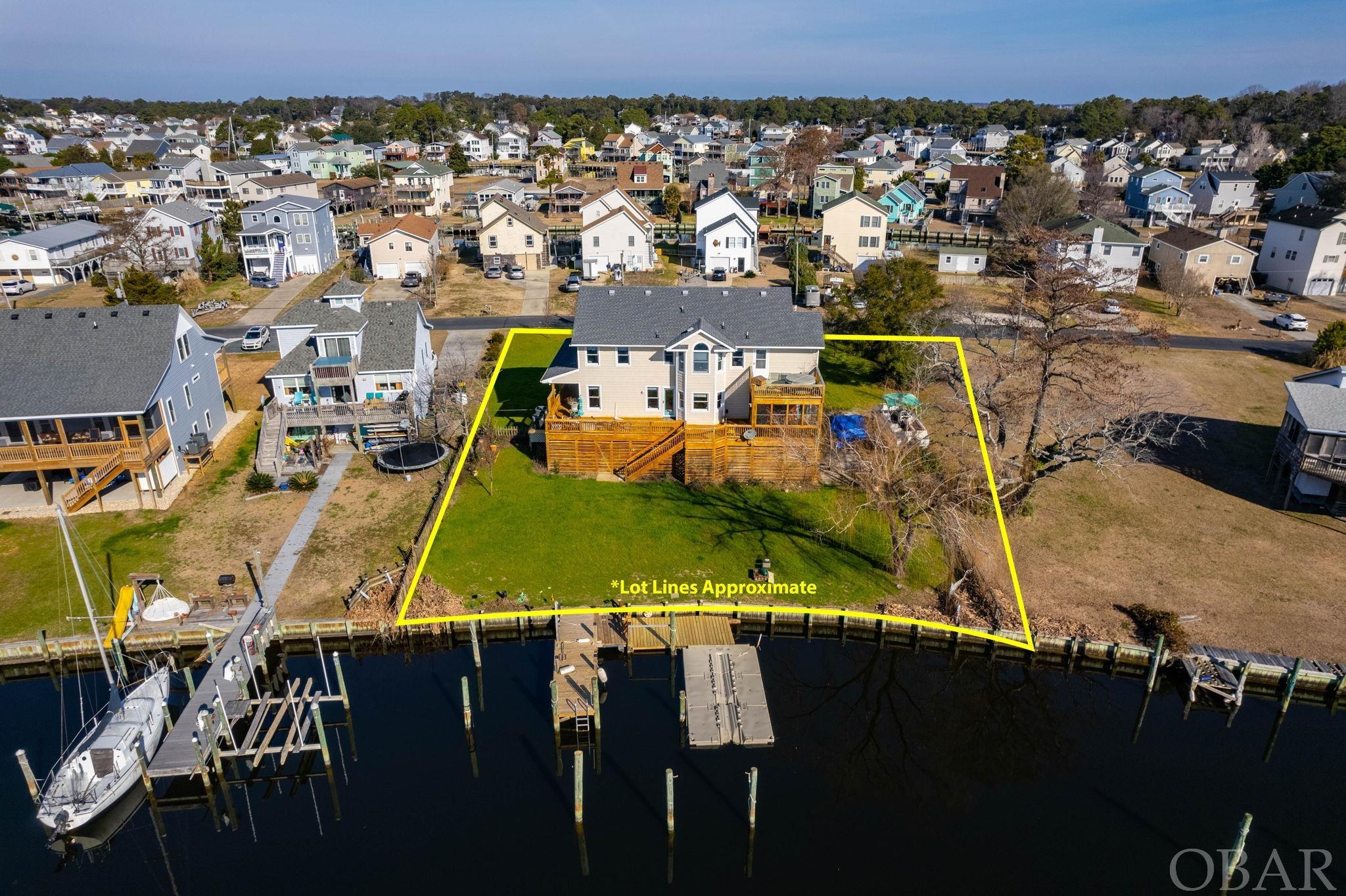 110' CANAL FRONTAGE. 2 1/2 LOTS! OVER 90K IN REMODEL, UPGRADES Canal leads to boat basin/marina, and out into the Albermarle Sound. Oregon Inlet, fishing capital of the world is a 30 minute run by boat.  Clubhouse, pool club is $200 per year