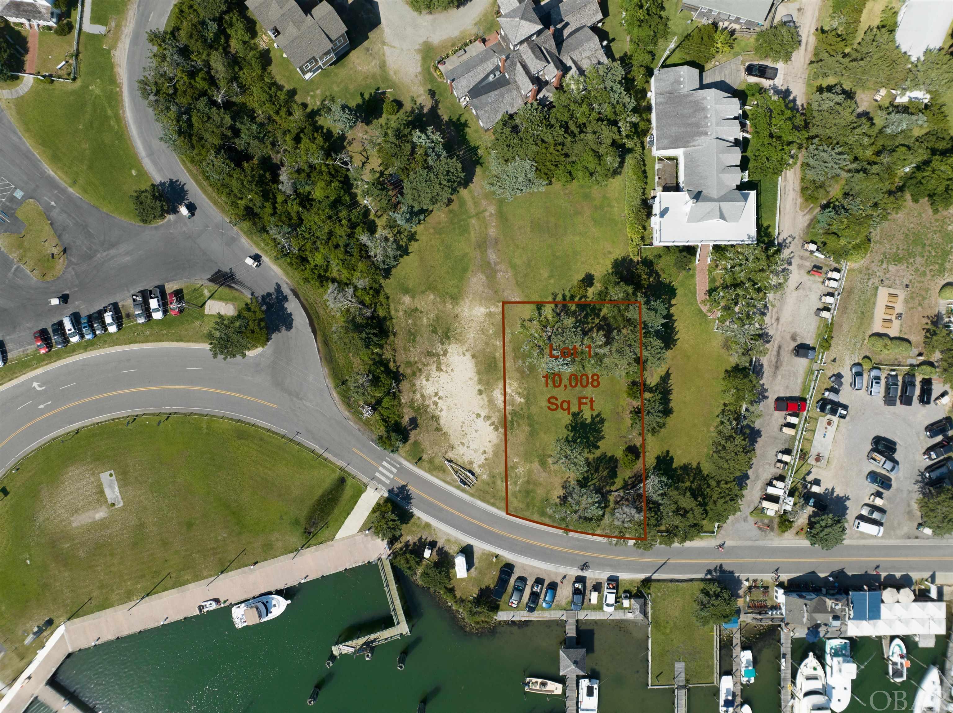 One of a kind opportunity to own a parcel of land with boundless potential in Ocracoke. Unimpeded views of Silver Lake Harbor make this lot the perfect location for any commercial or residential/condominium dreams. A community septic conveys as part of the subdivision and is located off site, rendering this entire lot buildable without the need for drain field installation. This is a distinctive location with unimpeded sunset views across the harbor, a rarity. Beautiful mature live oaks and cedars promote the coastal ambiance. This is the second private parcel from the NCDOT ferry terminal as visitors from the passenger and car ferries venture into the village. Heavy foot and vehicular traffic pass this location daily. Engineered building plans for a 60 seat/24 barstool restaurant with rooftop deck on file and could convey with parcel. This parcel has sister listings of the adjacent lot, marina boat slips, and Berkley that could compliment your vision. Lot could be expanded to 12,500 sq ft - inquire with an agent as to the possibilities this lot provides.