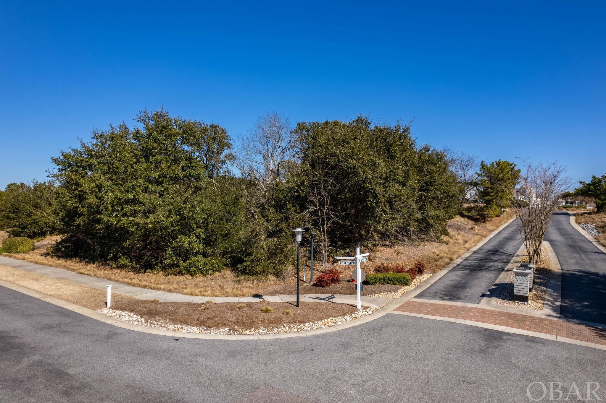 Gorgeous, elevated lot in the resort-style, gated community of The Currituck Club.  Enjoy possible sound views to the west and pristine golf course views to the east and south. Imagine your own brand new custom-built home on this X-flood zone corner lot in one of the most desirable neighborhoods on the OBX. Not only does TCC offer an abundance of amenities including multiple pools, tennis courts, in-season trolley service and more, the local attractions, restaurants, and shopping of Corolla are close-by.  Build your dream home now!