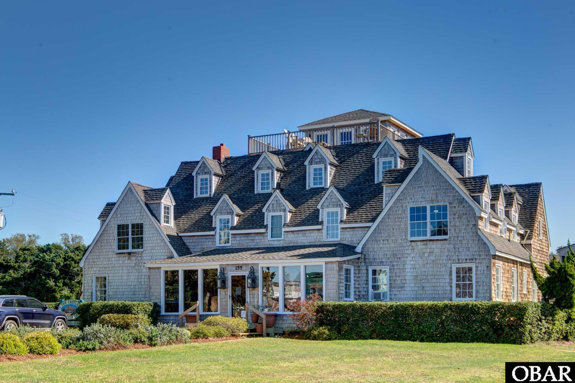 Here's your opportunity to own a successful turn key B&B on Ocracoke Island! The Castle B&B on Silver Lake is one of Ocracoke's most treasured landmarks. The Castle is a visually striking structures on the harbor, with its steep-pitched roof, many dormers, roof-top widow's walk and cedar shake exterior. This unique structure with Outer Banks style has a past as colorful as its architecture. Built in 1954 for wealthy industrialist Sam Jones, The Castle is on the National Register of Historic Places. In the late 1990's, The Castle was modernized providing private bathrooms for each of the 12 bedrooms. All of the original wood walls, ceilings and trim-work (beautiful dental molding in most rooms) are intact. Central heat and a/c on first floor and mini splits for the remaining floors. The Castle offers a refined and upscale accommodation option while still maintaining the casual feeling of a historic Ocracoke cottage. The common areas include a gracious kitchen, elegant dining room, several sitting areas, parlor with a pool table and gas fireplace. The Castle shares the a pool, pool house and its amenities, bikes, parking, grilling area and floating dock. Each of the 12 rooms have beautiful antiques and several have views of Silver Lake. The Castle B&B has wonderful exterior spaces including 2 screened porches, 3rd floor back open deck with a distant horizon ocean view and a front open deck with 180 degree views of Silver Lake, the Sound and the Ocracoke Lighthouse. Most rooms have original oak flooring and cypress ceilings. First floor consists of the office, parlor, snack hall, dining room, kitchen, laundry room and 4 bedrooms. Second floor has sitting area, furnished screened porch, small library, new deck, common wet bar and 7 bedrooms. Top floor has 1 large bedroom with living area, additional entry sitting area, wet bar, large shower with view of lighthouse and access to a shared widow's walk deck with unbelievable views. The Castle is a successful B&B; however, it could also be a 12 bedroom residence.