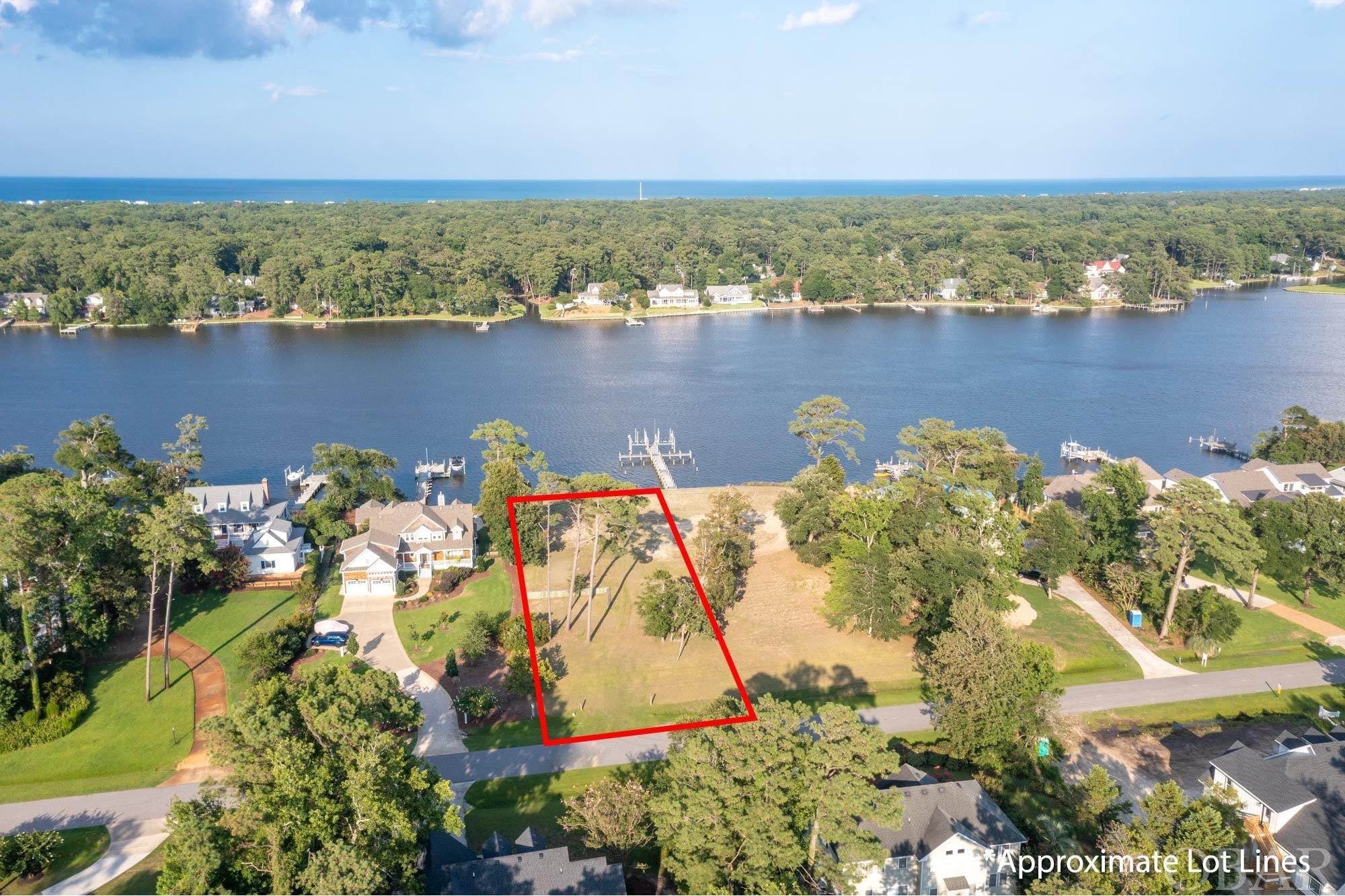 Located in the esteemed guard-gated community of Martins Point on the Outer Banks, this build-ready parcel with appx. 100 feet of water frontage sets the stage for the home of your dreams. Offering breathtaking vistas that stretch across the Jean Guite Creek, this approximately 30,000 square foot lot is one of the last available vacant lands in this peninsula community.  The heavy duty, double reinforced vinyl bulkhead has been constructed with the best craftsmanship and materials available.  The ground elevation is estimated to be 10’, and the property is cleared and maintained.  Residents of Martins Point can take advantage of the superb amenities including a marina, boat ramp and dock, park, and 24-hour guard security.  Presenting an unrivaled lifestyle and location near the miles of Outer Banks beaches, this offering is not one to be missed. The adjoining lot is also available – see MLS 119787.