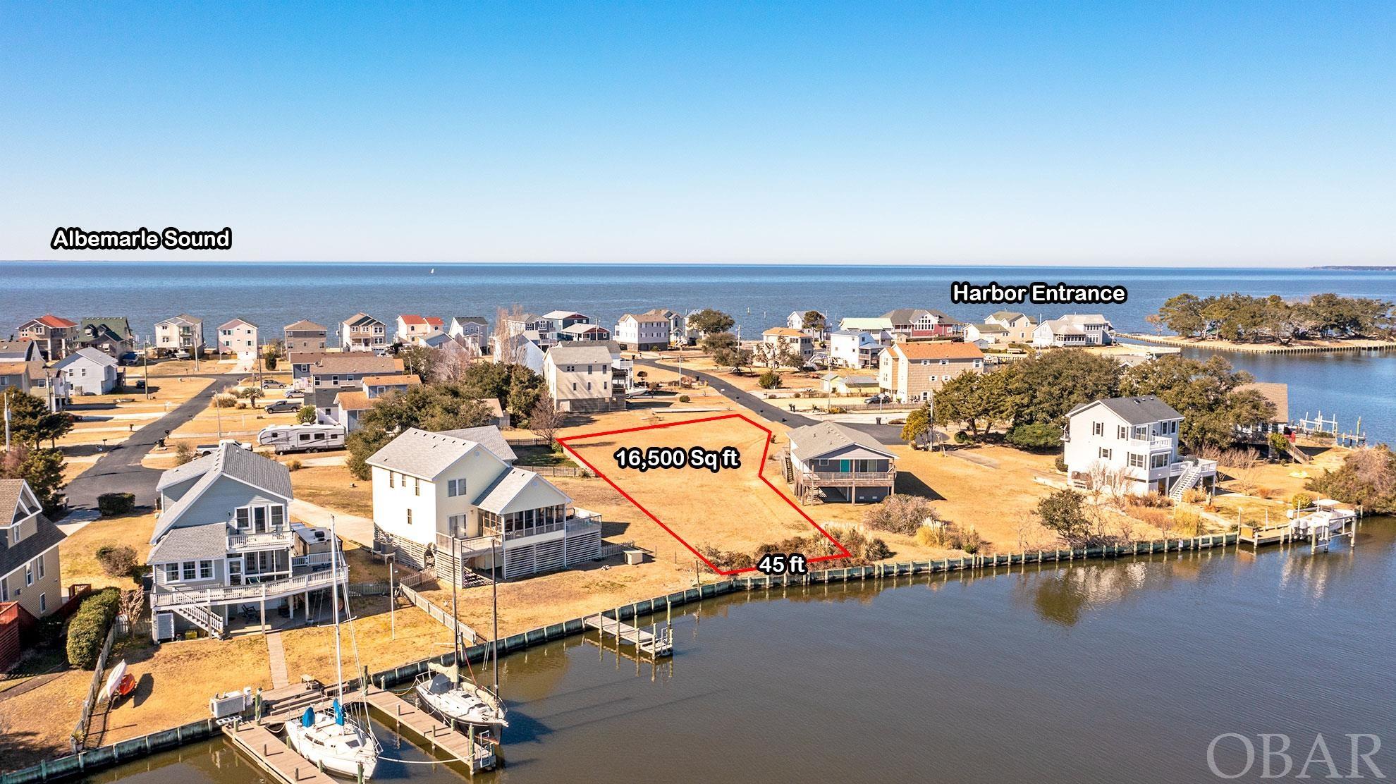 110 Club View Ct. is a RARE, beautiful, oversized canal front lot on a wide canal, just around the corner from the Harbor, providing great protection for your boat and, quick and easy access to the Albemarle Sound! Build your dream home and bring your boat! Dare County shows the lot substantially in an X Flood Zone! You will enjoy beautiful views of the wide canal from your new home with potential for both harbor and sound views as well. All in a quiet neighborhood location in the gated community of Colington Harbour. Build a dock and add a boat lift and you will be all set for great fishing, crabbing, or a sunset cruze. Colington Harbour offers a sound side park, picnic pavilion area, playground, boat ramp, and a basket ball court. The pool, clubhouse, and tennis can be joined for an additional fee. Emanuelson & Dad installed a brand new vinyl bulkhead 8/13/22! Don't miss out on this rare opportunity! This listing is for Lot 1 SITE-LTS 61&62. Taxes and HOA fees are for both lots.
