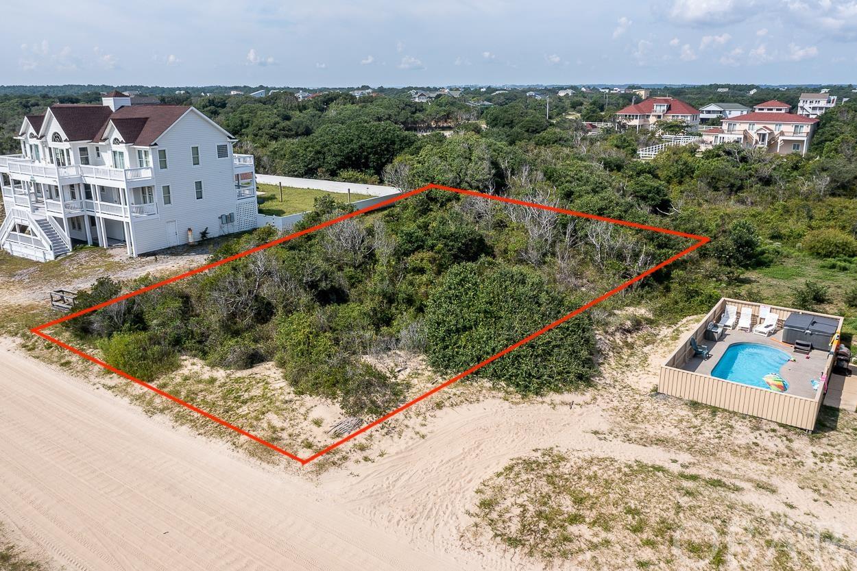 This is your opportunity to own one of the best semi oceanfront lots in the 4x4 area of Carova Beach! Build the beach house you always dreamed of. Enjoy watching the wild Mustangs run about. The Atlantic Ocean is right across the road for easy beach access and excellent views. If you are looking for a slice of paradise and quiet privacy, this is it! Don't miss out on this amazing opportunity.