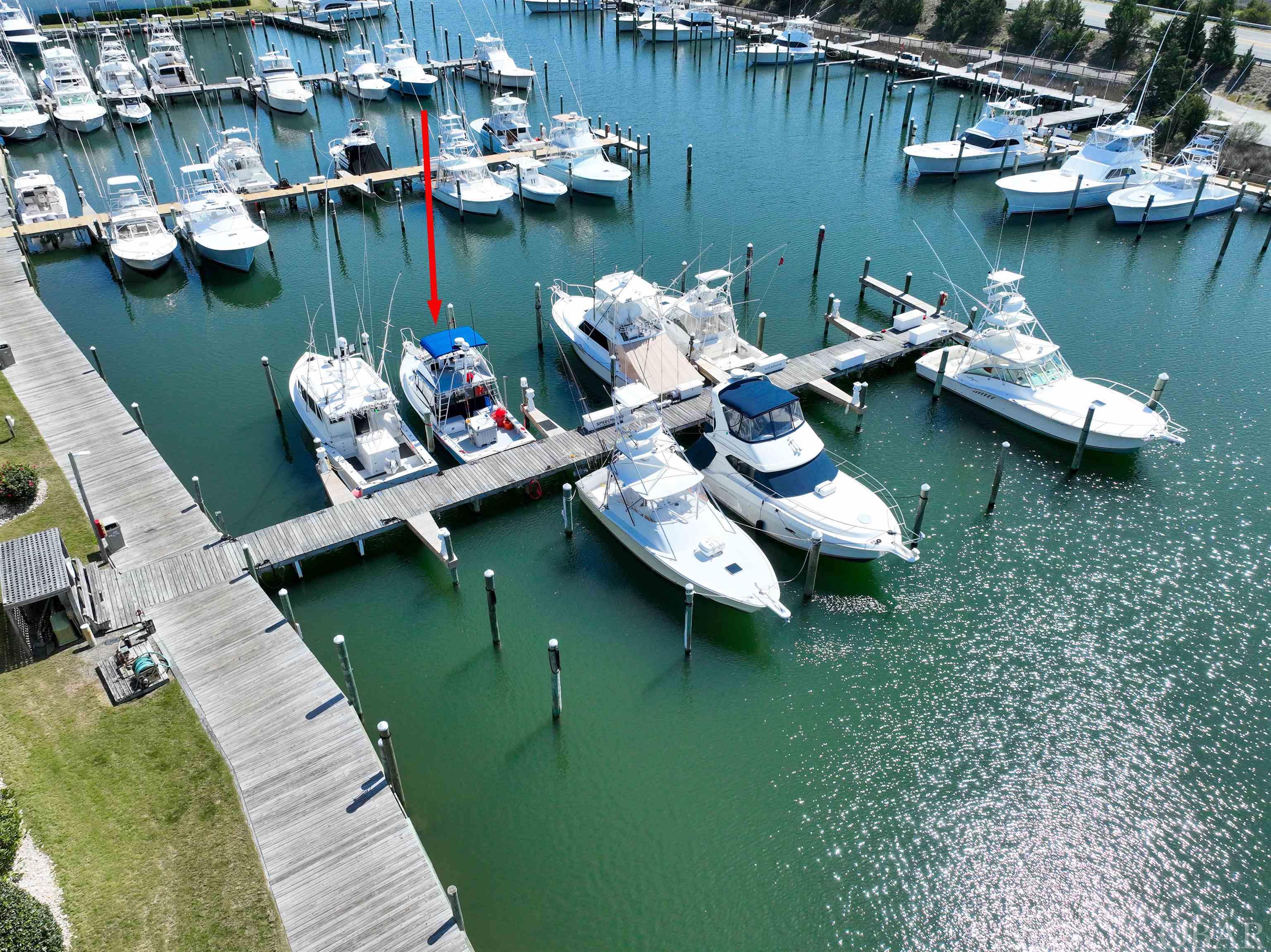 Welcome to Pirates Cove Marina in the charming coastal town of Manteo, NC! We're excited to offer a fantastic opportunity for boaters to own their very own slip in this premier marina. This particular slip is located in a prime position with easy access to the Atlantic Ocean. It can accommodate vessels up to 50', making it a great option for a range of boat sizes. You can even rent your slip by the night, week or month.    But that's not all - owning a slip at Pirates Cove Marina also gives you access to a wide range of resort-style amenities. Take advantage of the swimming pool, hot tub, and clubhouse, or hit the tennis and basketball courts for some friendly competition. You can even grab a bite to eat at the on-site restaurant and tiki bar.  When you're ready to explore the surrounding area, you'll find no shortage of things to do. Manteo is a quaint town with plenty of shops, restaurants, and cultural attractions to enjoy. And with easy access to the Outer Banks, you'll have miles of beautiful beaches, nature preserves, and historical sites to explore. Don't miss out on this amazing opportunity to own a boat slip at Pirates Cove Marina!