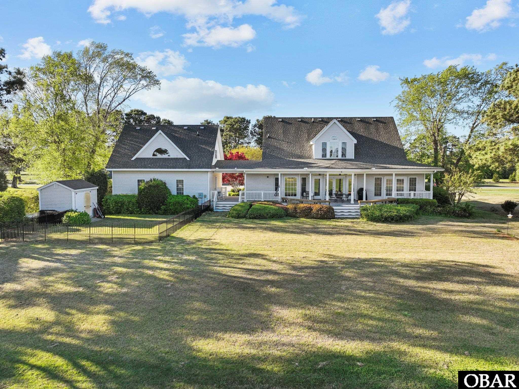 partially fenced in backyard and storage shed