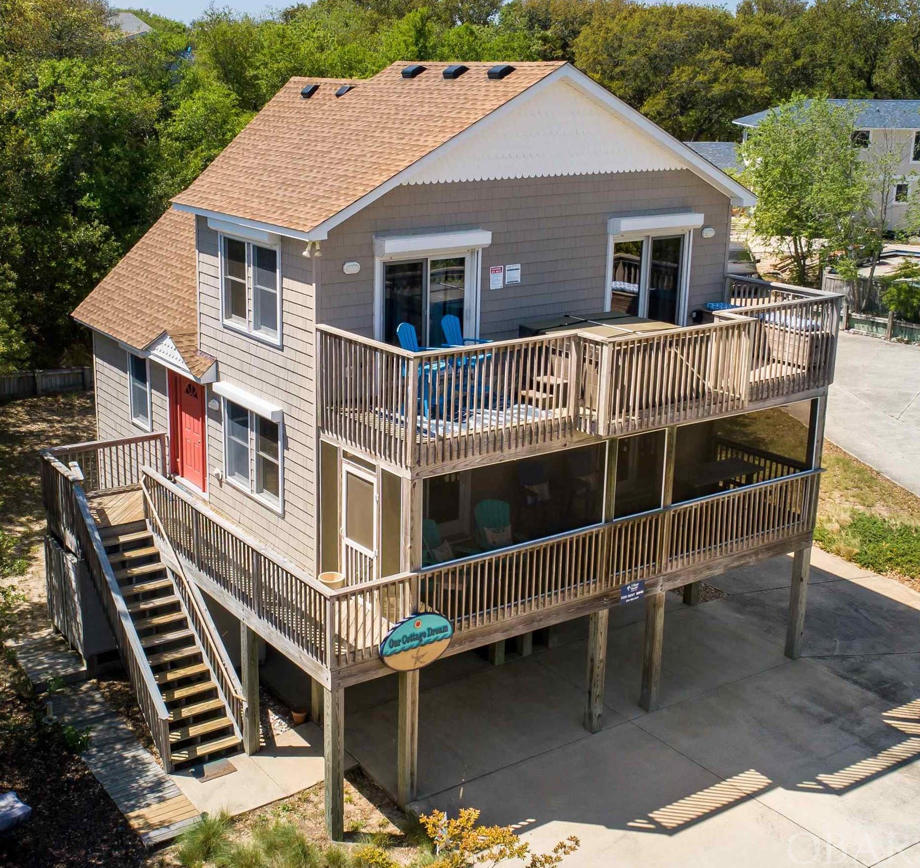 Wanting to live in Southern Shores... this is your lucky day. Just move in! This traditional Saltbox on pilings is less than 1/2 mile to the beach access. This comfortable and meticulously maintained home is nestled in center of private cul-de-sac that backs up to the sound, right next to the SSCA private relaxing path that ends at the sound. Civic Assoc. is voluntary but for under $100 a year, you get all the perks of beach life. 3 large comfortable bedrooms plus multi use loft and 2 full bathrooms. Kitchen boasts all new appliances and interior has all been recently painted.  ALL furnishings less owner's personal items and the 5 piece heavy weight vinyl style deck seating. (Double Seat does NOT convey), but owner will leave the new 4 piece set (2 high-top and 2 low wide back Adirondeck style chairs) on deck valued at over $1200. with ACCEPTABLE OFFER by end of April. Sellers are second owners that have personalized this beauty with some true beach accents.  The soft inviting coral and teal color scheme through-out reminds you that you own a home at the beach. You will immediately feel at home comfortably surrounded in that dream beach home, vacation home, 2nd home or absolutely your primary residence! Current owners do rent this almost 2000 sq.ft cozy cottage during a short 20 week season that does give them a positive cash flow for the summer but they truly enjoy it more when they get to have it all to themselves and family. It is tastefully decorated through out with some real show stoppers including a barn door to a huge laundry room on the ground floor with dry entry to an inviting open foyer downstairs and easy access to levels 1 and 2. Sellers have installed new roof, replaced some lights/fans, some bathroom accessories/fixtures and installed LVP flooring everywhere except kitchen and utility room. Home was custom built by Blue Hoffman in 2002 but honestly would pass as a much newer home due to all the updates and upgrades.Tons and tons of storage including easily accessible hot water heater on ground floor with lots of extra room for holiday or seasonal storage.Plus each bedroom has a nice size closet. Front top level bedroom has sliding glass door to sunbathing deck and hot tub. Owners have thought of everything, including sand buckets, toys, games, corn hole boards, large grill, chairs, umbrella and a complete kitchen giving you all the accoutrements to make dinner your first night here! Weekly rentals for summer must be honored with current management company, but rent proceeds transfer to new owners.  After what's on the books now, feel free to discontinue renting and call it home OR continue to keep renting and hold some summer weeks for yourself. Some more extras include hurricane shutters on main and top levels, property is not in a Flood Zone requiring insurance coverage and owners do not pay flood insurance. Over sized double driveway will accommodate minimum 8 cars! Plenty of room for a pool that will require minimal relocation of some septic lines that owners are being told is easy and can be done while pool goes in! Deck off of main floor is now newly screened in! Don't wait... this is it!