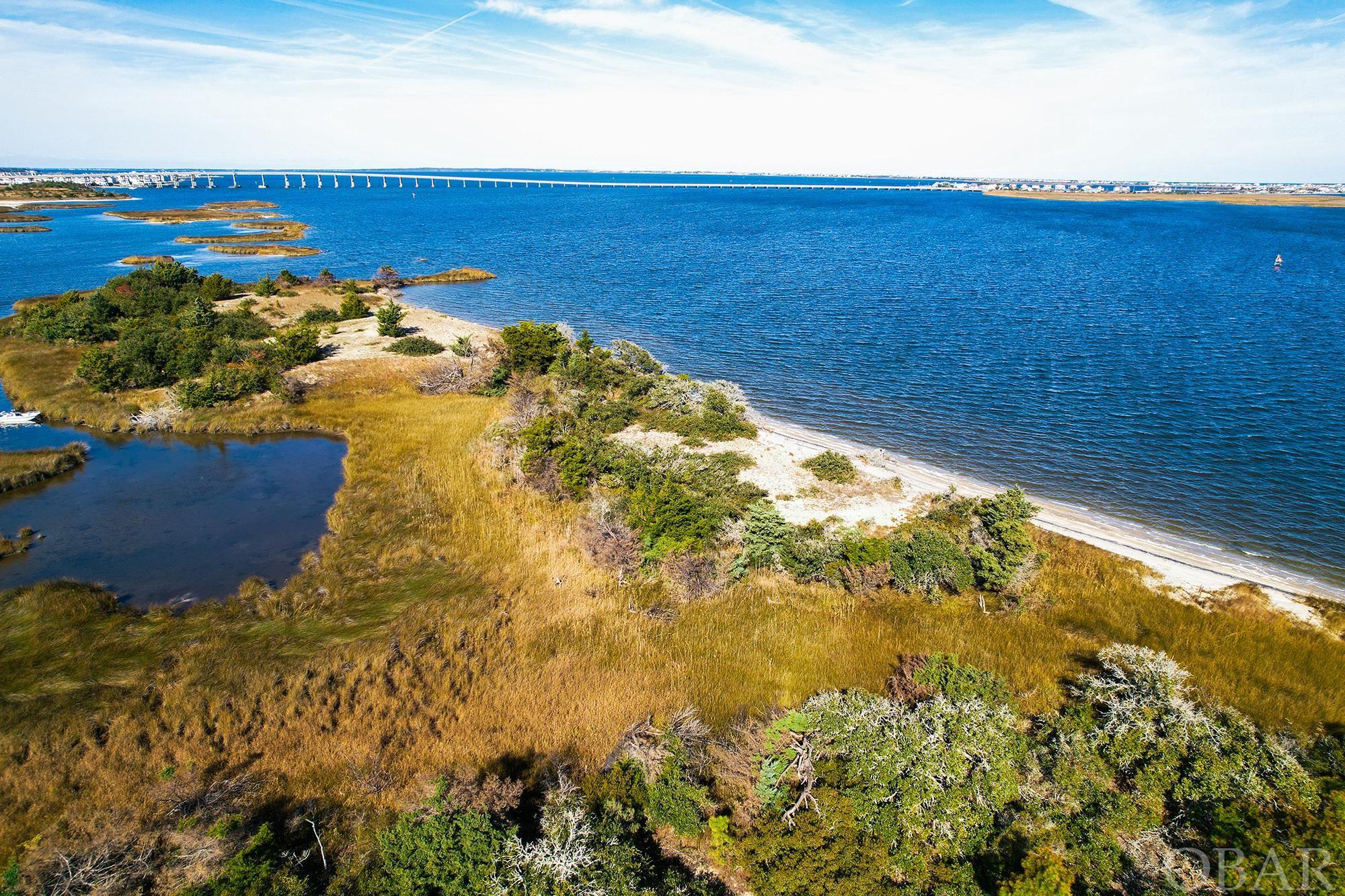 Waterfront and Private Living at its Finest...Just South of Pirates Cove and South of Virginia Dare Bridge makes this Lot Location Second to None. Viewable from the Bridge and a short distance to this Soundfront Lot on The Roanoke Sound. Peaceful and Private describes how you will live your Outer Banks Dream. Located on the Main Channel to Oregon Inlet where Dolphin Watching in your front yard is a daily Occurrence, you will wake up every day needing to be pinched. Call to schedule your private tour of the Carolina Cays   For Outer Banks lovers it will never get better than this.