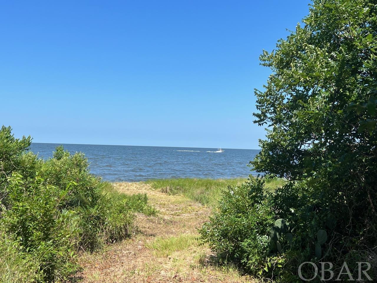 REDUCED!! PREMIER SOUNDFRONT BUILDING SITE in Colington Harbour!!  EXCELLENT ELEVATION; VERY LARGE SITE! Approx. 80 FEET OF WATER FRONTAGE W/BULKHEAD! Enjoy spectacular SUNSET VIEWS over the lovely Albemarle Sound! One of the few remaining sound front building sites on on the Outer Banks!! Build your dream home & experience waterfront living at it's finest! Boat, kayak, paddleboard, swim, fish crab from your back yard! Clipper Ct. is a quiet cul-de-sac is just minutes to the fabulous community amenities: Marina, boat ramp, huge sound side park with sandy beaches, playground & covered picnic areas!  For a nominal fee, join the Colington Harbour Yacht & Racquet Club and enjoy the Olympic size salt-water pool, kiddie pool, tennis courts, community clubhouse w/fun activities!