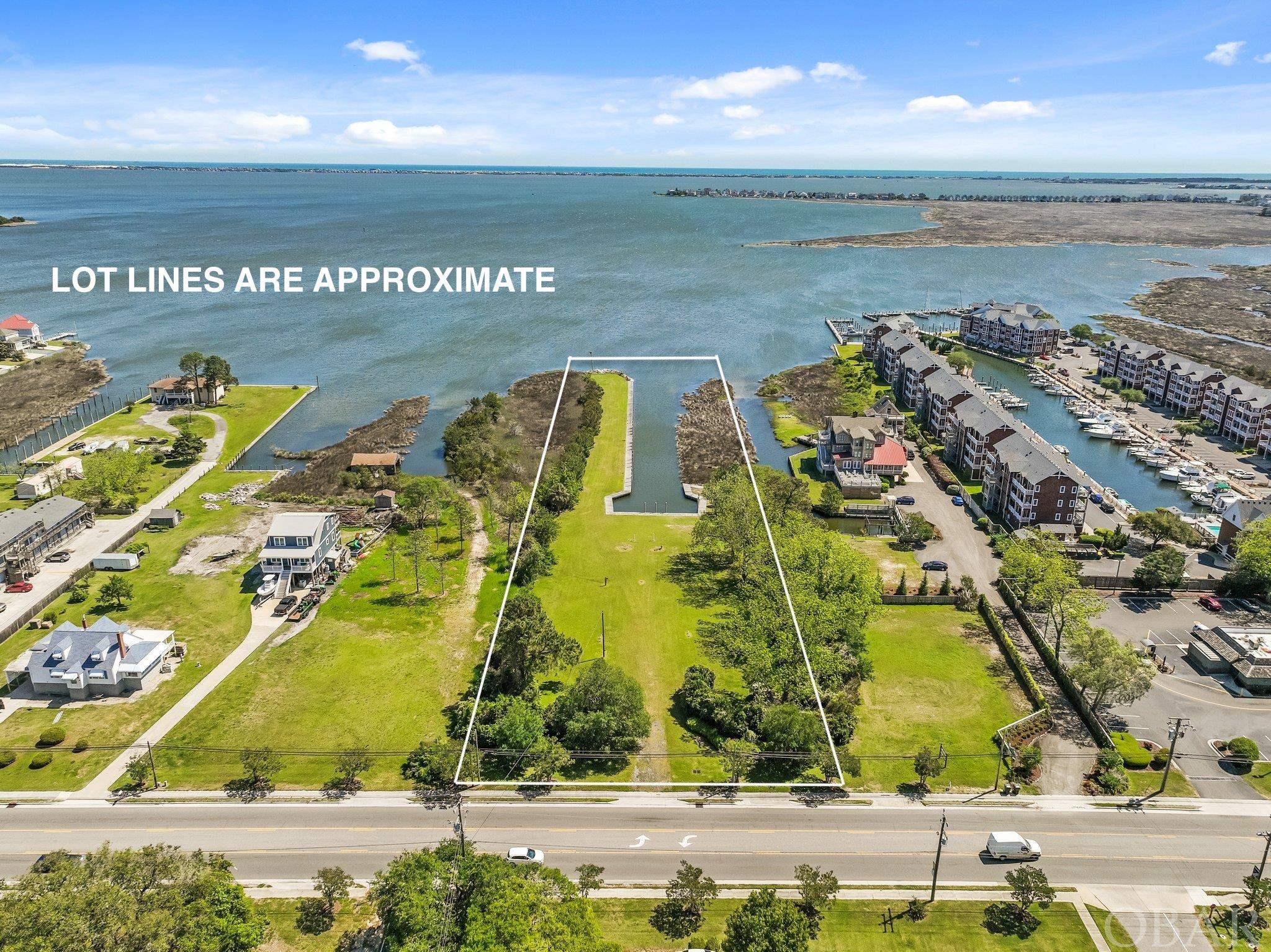 Manteo Waterfront Opportunity!  Development Opportunity!  A Special Property!   3.19 Acres of Prime waterfront near historic downtown Manteo.  Comprised of two parcels totaling 3.19 acres, there is 175 feet of street frontage, a 40 foot wide deep water canal and boat basin, 589 linear feet of bulkheading, dockage, boardwalk and incredible water views!  The parcel is zoned B2, which offers a multitude of potential uses that could be residential, commercial or mixed use.  Considerable expense has already been invested in the land including clearing, dredging of the canal, bulkheading and the addition of infrastructure including water, sewer and power.  This one is ready for development!  Several concepts have been created by engineers and surveyors to show the possibiity of single family development or mulit-family development.  Call agent for more details.  Amazing location near Historic downtown Manteo, Shallowbag Bay Marina, Pirates Cove Marina and all the Outer Banks has to offer.  Nothing compares to this waterfront opportunity!  It's rare combination of water frontage, deep water access, boat basin and development opportunity makes this a one of a kind property!