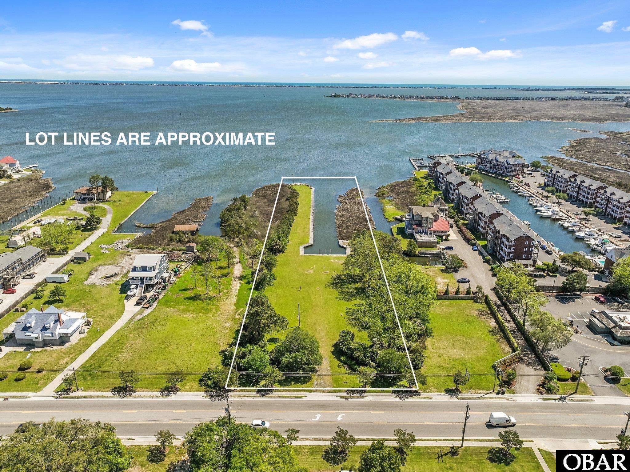 Manteo Waterfront Opportunity!  Development Opportunity!  A Special Property!   3.19 Acres of Prime waterfront near historic downtown Manteo.  Comprised of two parcels totaling 3.19 acres, there is 175 feet of street frontage, a 40 foot wide deep water canal and boat basin, 589 linear feet of bulkheading, dockage, boardwalk and incredible water views!  The parcel is zoned B2, which offers a multitude of potential uses that could be residential, commercial or mixed use.  Considerable expense has already been invested in the land including clearing, dredging of the canal, bulkheading and the addition of infrastructure including water, sewer and power.  This one is ready for development!  Several concepts have been created by engineers and surveyors to show the possibiity of single family development or mulit-family development.  Call agent for more details.  Amazing location near Historic downtown Manteo, Shallowbag Bay Marina, Pirates Cove Marina and all the Outer Banks has to offer.  Nothing compares to this waterfront opportunity!  It's rare combination of water frontage, deep water access, boat basin and development opportunity makes this a one of a kind property!