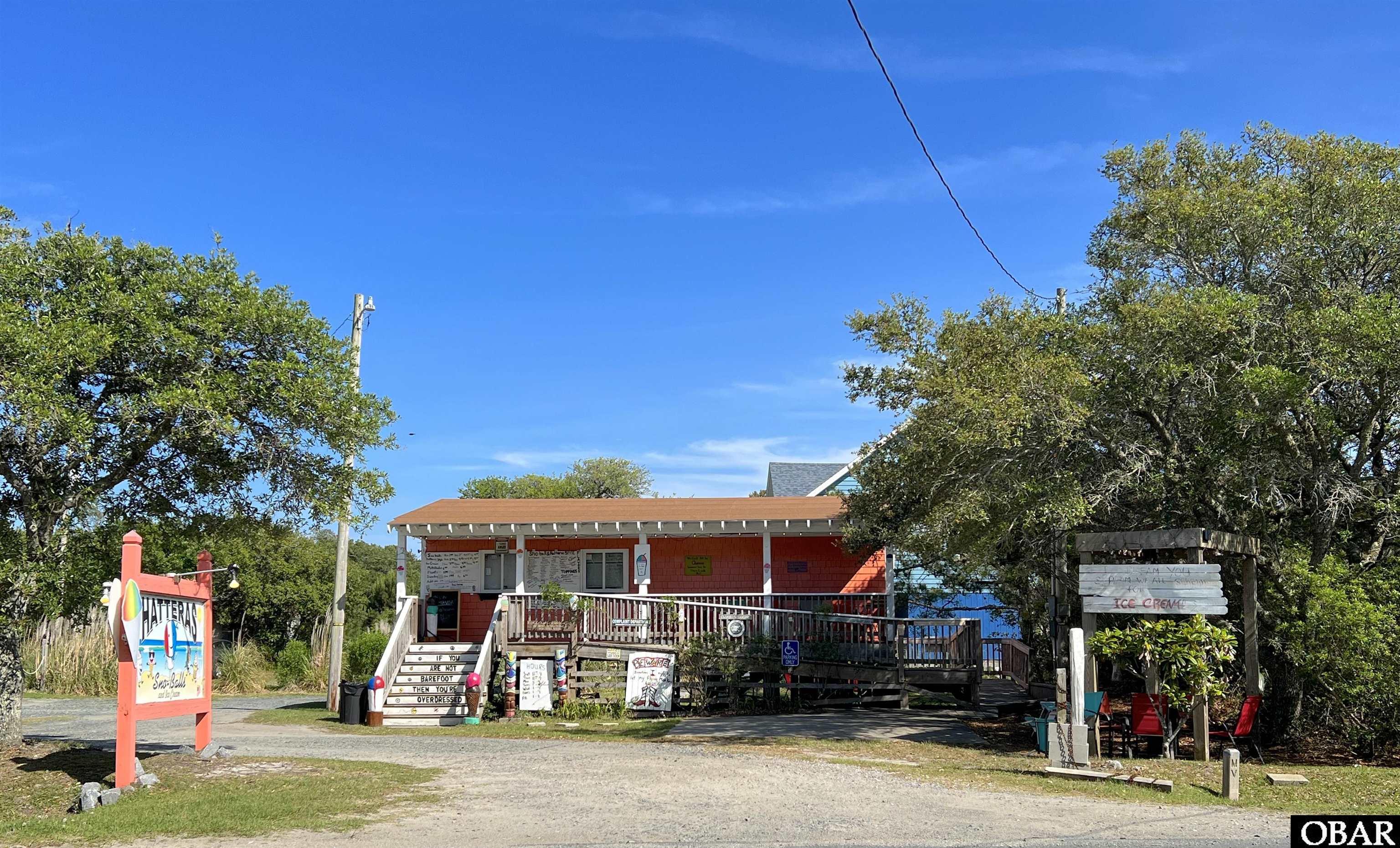 Live the Hatteras Dream! Sell Sno-balls on Hatteras Island! You do not want to miss the opportunity to own this iconic Frisco business complete with beautiful housing! Hatteras Sno-balls is an iconic sweet treat spot loved by locals and visitors alike for many years. This is your opportunity to work SEASONALLY and enjoy Hatteras Island living year round. Included in this sale, is a beautiful three bedroom two bath home that sits adjacent to the business on the same property. No commute! Walk to work! The house is being used as a short term vacation rental by the owner and brings in a good annual owner income but if you are looking to relocate it will serve as your very own Hatteras Island home! Hatteras Sno-balls is located in the heart of Frisco Village, just north of Cape Hatteras Campground, restaurants, shops, attractions, and just minutes from the beautiful Frisco beaches!  Who wouldn't stop and get a Hatteras Sno-Ball on their way home from the beach on a hot summer day or a return day trip from Ocracoke Island? Live the Hatteras Dream! Come and see it today before it's gone!