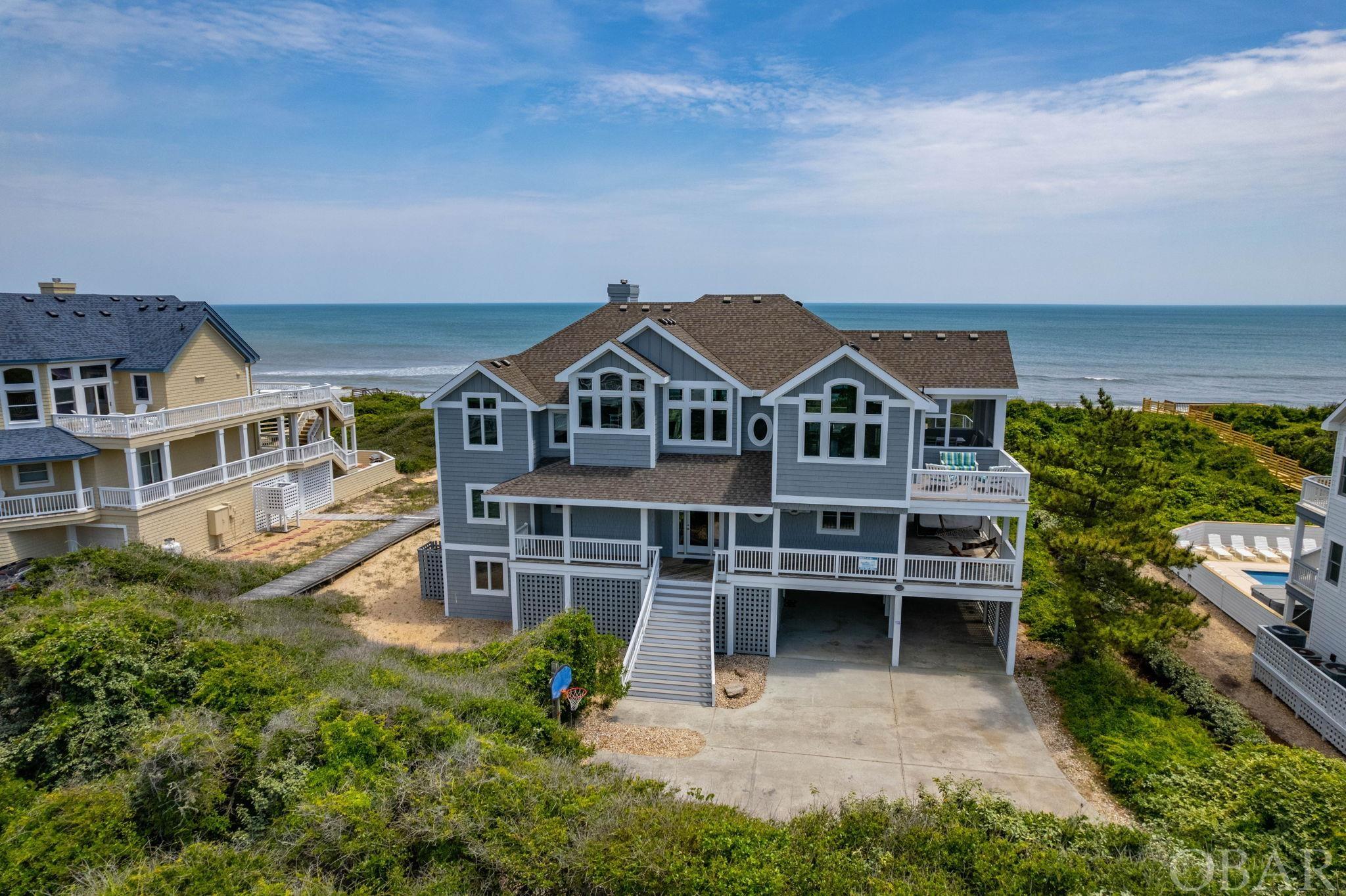 Refined oceanfront in the coveted community of Pine Island. This 7 bedroom, 7.5   bath, spacious home is an absolute show stopper. Step inside Zen Life to a completely care free zone where all the upgrades and renovations have already been completed for your family. The ground floor is perfect for the young at heart where you can watch sports, play pool or just decompress. There are two bedrooms that share an adjoining bathroom. The open expansive pool area features a gunite heated pool, hot tub open to the stars at night, a hammock to sunbathe, outisde shower and access to a full cabana bathroom. Simply ride in the elevator to a mid-level where you will find the front entry way/foyer and 4 ensuite bedrooms with stylish furnishings, artwork and deck space. There is also a second hot tub on the south east corner that provides excellent privacy for large groups. The top floor boasts beautiful panoramic views of the ocean and sound. Gorgeous refinished hard wood floors shine and showcase the wall of windows facing the Atlantic Ocean.  This floor provides comfort and class for your guests and family. There are 2 refrigerators, 2 dishwashers, a wine cooler and high end gas cooktop and oven for the cooking extravaganza to begin. The recently redone TREX decks and stainless steel rail system exude the modern feel of beach living. With all the renovations done, there is nothing left to do except meditate in the bliss of a day in Zen Life. Some of the recent upgrades: new HVAC 2021, ice maker, top floor bathroom remodel, all new quartz countertops for 6 bathrooms, refinished hardwood floor, mid-level and ground floor Luvury Vinyl Tile and paint, 3 new dishwashers and refrigerator, exterior paint, PVC trim and PVC soffits, 4 new sliders, 8 new windows, pool deck releveling, and a new gas stove. Drift away today in this dream home.