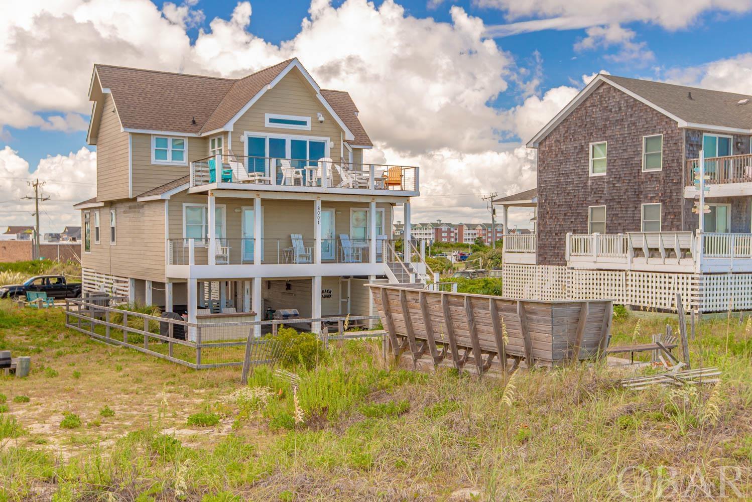 ONE OF A KIND!!!  This immaculate oceanfront home is truly an Outer Banks GEM!  From the awesome location to the ocean views to the luxury interior, you will find no better place to be to enjoy all that the Outer Banks has to offer.  The interior has no match with its exposed beams, reclaimed hardwood floors, spectacular artwork and it's luxurious furnishings.  The kitchen is complete with granite countertops and stainless steel appliances and gas range.  Off the kitchen you will see sliding glass door that opens from both sides and exposes the panoramic views of the Atlantic Ocean. Directly opposite of the sliding doors which open to a very entertaining deck is a private queen guest room with a full bath.  The entire first floor is made for entertaining.  The 2nd floor comes complete with 2 king master suites with full baths and 2 additional guest suites next to an additional guest bathroom suite.  All rooms are furnished with top of line furnishings that give a vibe of coastal living combined with luxury lifestyle like no other.