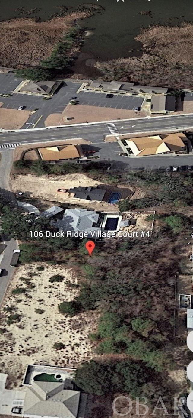 Being in the heart of Duck, this homesite is for a buyer who wants to be in a private location but be able to easily walk to everything that the quaint town of Duck offers, including the Town Park, restaurants and shops. With a 2-3 story home, one should have views of the sound as well. The lot is in an X zone (No flood insurance required). There is a minimum amount of AE zone on the west side in the setback area of the lot which should not affect the future structure. (See copy of the survey in the Associated Docs) A site elevation is also in the Associated Docs showing a typical 6 BR drawn on the lot. Residents of the Duck Ridge Village subdivision may also join, if memberships are available, the Schooner Ridge Recreation Center to enjoy the amenities they provide. The subdivision has very nice homes in a private setting on a cul-de-sac ranging in value of 3/4 to a million plus dollars. Plan to come by and check this lot out to see why it is so special!