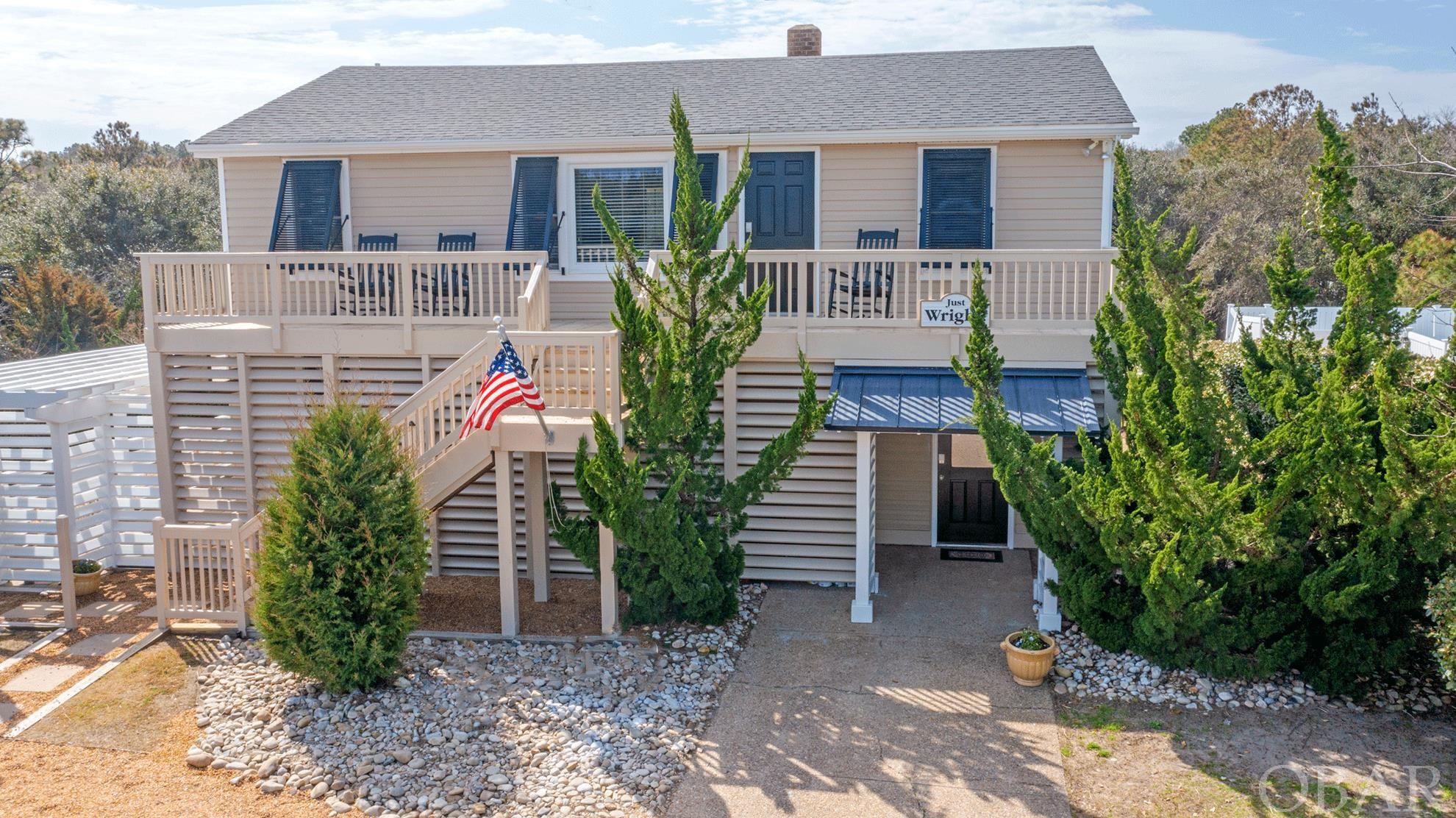 DIRECT BEACH ACCESS across the street. Classic beauty on a 32' high dune ridge in the quaint town of Southern Shores. Property has been immaculately kept and meticulously maintained as a primary residence and has been used for a multi-generational family. Could also be used as a great vacation rental or second home. Easy beach access within minutes to NC 12 crosswalk. Close to stores and restaurants by foot or take the bike path. The house offers two units one on each level. Each level has its own individual central air and heat Upstairs you have three bedrooms with living and kitchen and one bath with interior offering original tongue and grove walls and ceilings, and hardwood floors throughout, with central heat and air conditioning. The larger bedroom is located on the southeast corner, offering a roomy king size bed with new carpeting. The northeast bedroom easily fit a queen size bed and the third bedroom was used as office space. Upstairs updates include newer kitchen cabinets, counter tops,  fixtures and stainless appliances and tons of recessed lighting. Ceramic flooring in kitchen and bath, along with tasteful custom shower and builtin shelves for storage.. Lower level offers two bedrooms, kitchen, and living room with electric fireplace. The additional office space/baby room or whatever the buyer chooses it to be. Also separate laundry room. Lower updates include new cabinets, counter tops, gas range, stainless appliances and fixtures, and custom ceramic shower and tasteful fixtures. Outside improvements include custom operable storm shutters, a Pergola to enjoy from getting too much sun or to relax with a morning coffee or your favorite beverage in the evening; a detached shed with plenty of shelving and storage space; and a fenced in dog-run area for your pup and plenty of parking. Rental Projection on file.