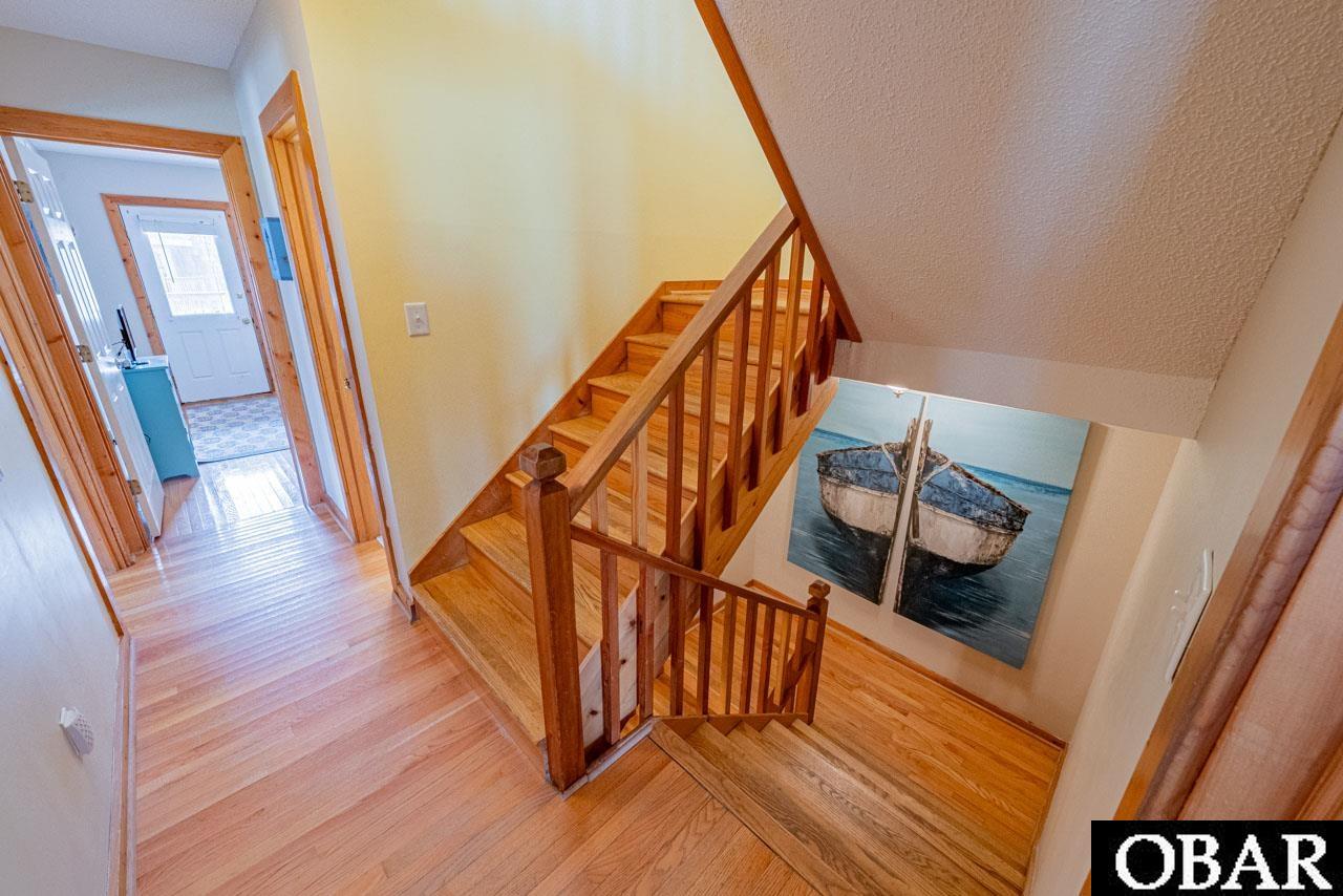 Mid level Hallway with steps to first and top level