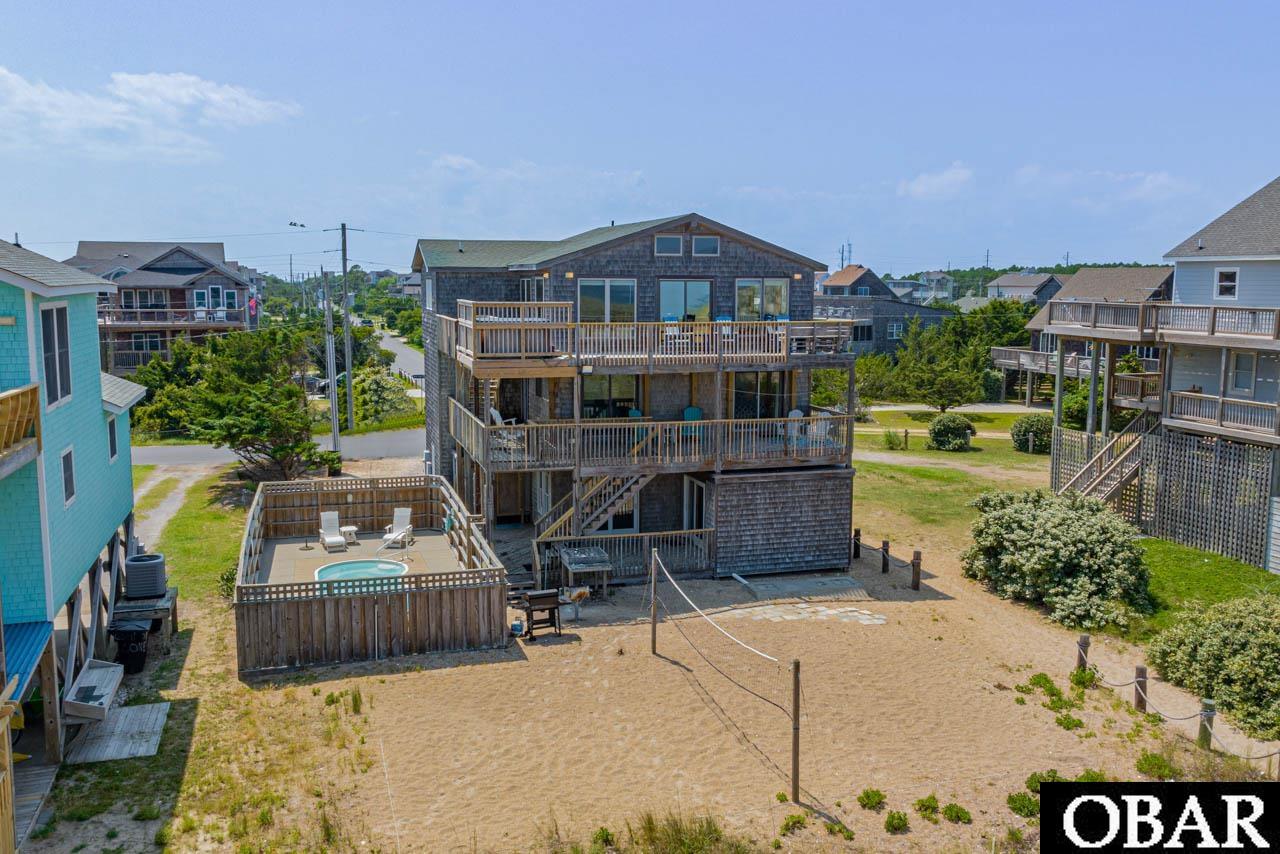 Escape the real world and experience coastal living at its finest with A Wave From It All! This extraordinary oceanfront home, nestled in the charming village of Waves, offers an idyllic retreat that combines breathtaking views, luxurious amenities, and an incredible investment opportunity. This home sleeps like a 7 bedroom with 5 full bathrooms, this spacious property provides ample room for relaxation and entertainment. Wake up to the awe-inspiring sight of the sunrise over the Atlantic Ocean, as panoramic views fill the home with natural beauty. Not only does this property offer a serene coastal lifestyle, but it also proves to be a smart investment, with a substantial income potential producing $120,000 for the 2022 season and already has $128,000 booked for 2023. As you enter the first level, you'll be greeted by your own private theater room, perfect for enjoying movie nights without ever leaving the comfort of home. Imagine settling down in the 17-seat theater, complete with a 9-foot HiDef screen, creating unforgettable moments with family and friends. The first level also features a game room with a pool table, a wet bar equipped with a microwave, refrigerator, and a 12-bottle wine cooler, ensuring your poolside snacks and beverages are always kept cool. Additionally, a pyramid bunk bedroom and a bonus room with 1 bunk set offer flexible sleeping arrangements. A full bathroom completes this level, providing convenience and comfort. Moving up to the second level, you'll discover four tranquil bedrooms where peaceful nights await you. Two queen bedrooms with sliders to the shaded deck, as well as a bedroom with two bunk sets, share a full bathroom off the hall. An en-suite queen bedroom is also available on this level, providing privacy and convenience for guests. On the top floor, indulge in relaxation and luxury within the en-suite bedroom featuring a Jacuzzi tub, ideal for unwinding after a long day. Enhancing the romantic ambiance, an electric fireplace creates a cozy atmosphere. The private bath also includes an additional shower stall for added convenience. Another full bathroom is available on this level. The open living, dining, and kitchen area is designed to capture the stunning views of the ocean and dunes, allowing you to immerse yourself in the beauty of the coastal surroundings. Step out onto the ocean view sundeck to witness breathtaking sunrises or soak your cares away in the hot tub under a blanket of stars. This incredible home is brimming with amenities that cater to your every desire. Relax by the solar heated pool or for those seeking more excitement, a beach volleyball court awaits behind the home, promising hours of fun and friendly competition. Just a short walk over the dunes will lead you to the sandy wide beach, where you can bask in the sun and enjoy a day of beachside bliss. Don't miss the opportunity to own this remarkable oceanfront home that offers an unparalleled coastal lifestyle and a solid return on investment. Schedule your visit today and embrace the coastal escape you've been dreaming of!