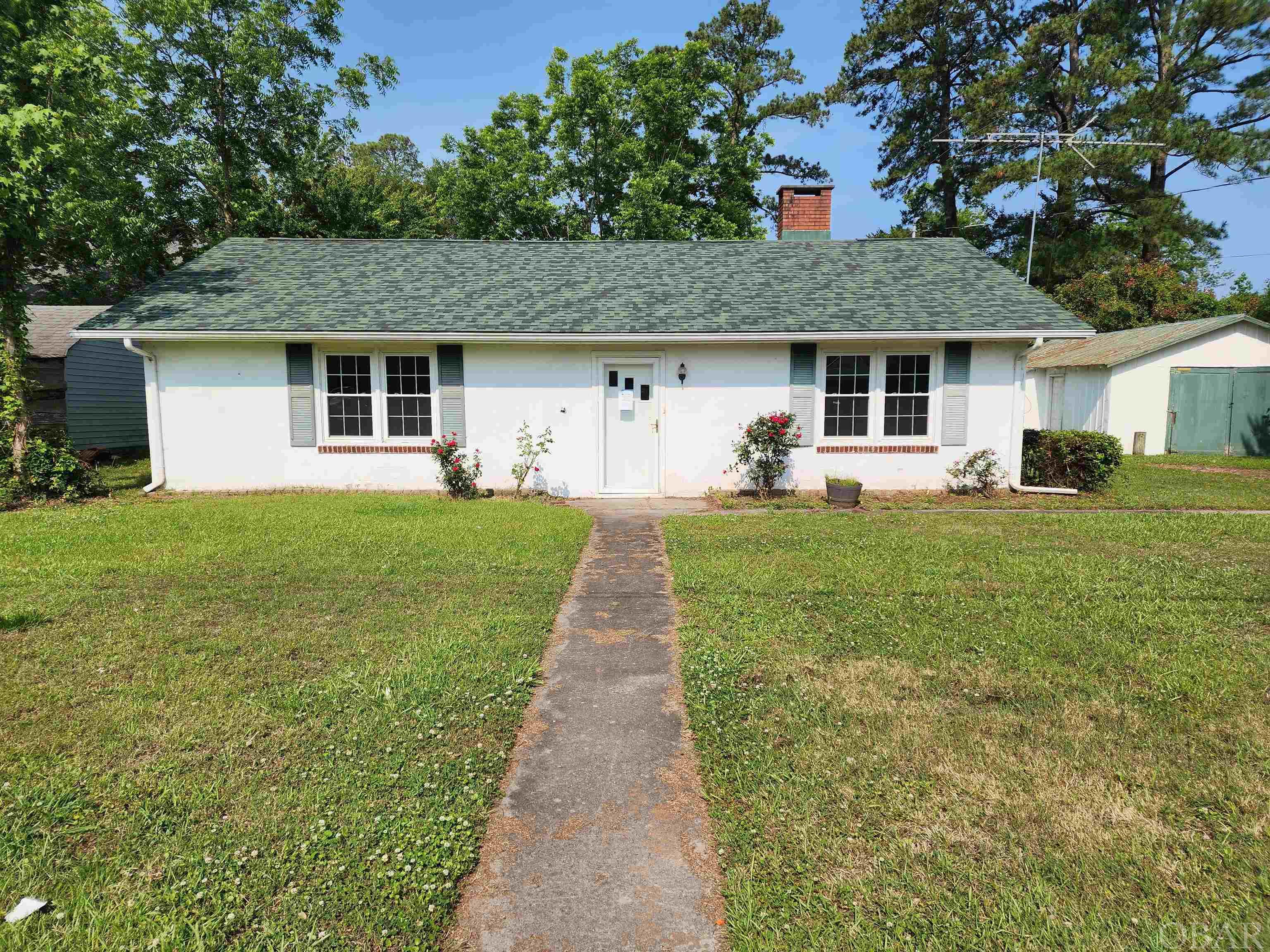 This cozy 2 BR, 1 bath home located within the city limits in the town of Columbia. Located on a low traffic dead-end street. Patio outside back door. Detached garage/workshop & storage shed.  Only short distance to schools, medical center, pharmacy, grocery store, restaurant and other amenities. No more than 45 minutes to beautiful Manteo & OBX! Newer roof and HVAC.