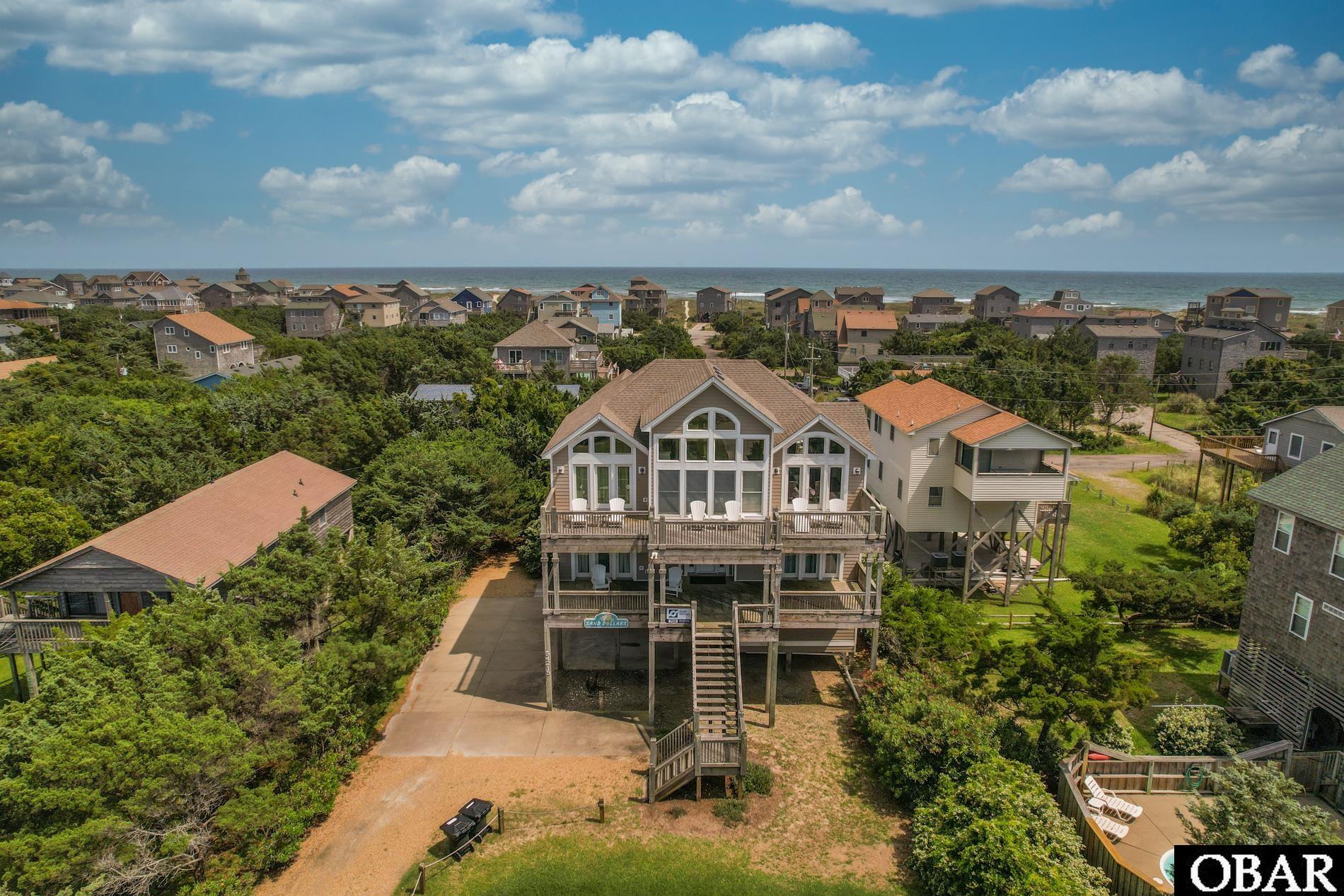 Wow! Prepared to be blown away at the amazing "Sand Dollars" This is a strong rental perfomrer and is ready to be your oasis with an in-ground swimming pool, large hot tub, secluded yard space, great room and kitchen perfect for entertaining and more! This home features 5 large bedrooms, 4 of which have their own ensuite bathrooms. 5 full bathrooms and 1 half accompanied by game room, there is so much to enjoy! Sand Dollars is cheerfully furnished and provides the utmost comfort for you and your guests. Exterior decks and covered porches offer endless views. Come off the beach and shower in the outdoor shower or head straight to the pool after using the foot wash station. Luxury abounds at Sand Dollars so make sure you call today and make this dream a reality!