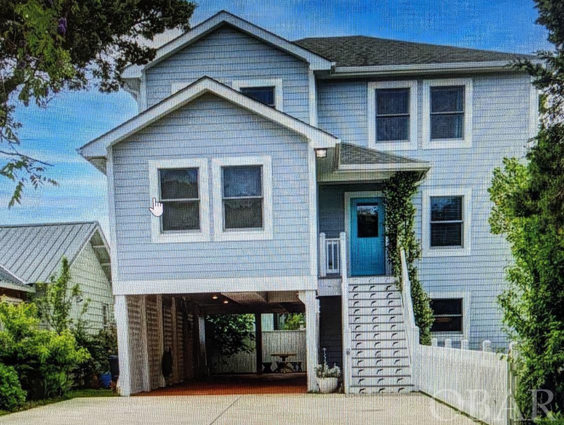 A beautiful, well built and maintained 4 bedroom/2.5 bath home in Wahab Village. Built by one of the top builders on Ocracoke for his personal family home for the last 12 years. 2023 is its first year on the weekly rental market and is already proving to be an impressive rental. First floor consists of the open "L" shaped living room, dining room and kitchen all with wood floors, a chef's kitchen with beautiful cabinetry, gas stove, stainless steel appliances, counter bar seating and recessed lighting. The first floor owner's suite has many windows for natural light, vaulted ceiling, wood floors, a ceiling fan, gracious closet space, an attached full bathroom with tiled floors and large vanity. The large screened porch is accessed via a sliding glass door off the living room. The second level has 3 bedrooms, a full bath with tile, wood floors, vaulted ceilings and an additional sitting area, great for kids gaming or watching TV. Central heat and a/c, extra energy efficient insulation (foam and regular), on-demand gas hot water heater and 2x6 framing studs. The underneath of the home and driveway are concrete, there is a patio with pavers in the back of the home, side fenced yard, screened porch, basket ball goal and 1/2 bath (plus shower) on the ground floor for convenience. Exterior newly painted in late 2022.