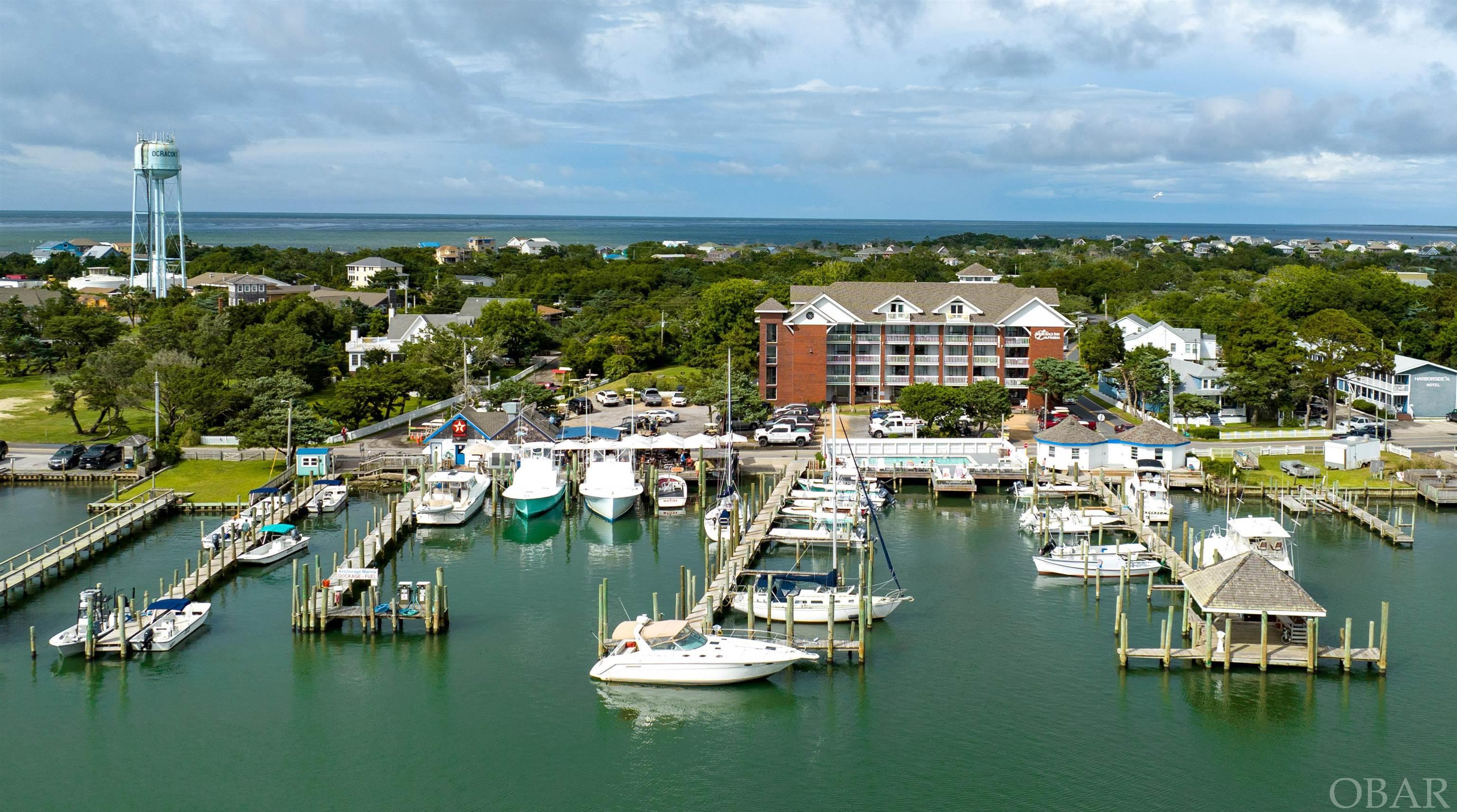 The Anchorage Inn, a 4 story brick and mortar hotel featuring 37 rooms, is a well known staple of Ocracoke's harborfront for over 40 years. Its location, perched above Silver Lake, provides views of awe inspiring sunsets that brings back guests year after year. Two large suites with full kitchens and private walk out balconies claim the uppermost floor. Harbor front pool with composite decking. Totally turn-key investment property. 4 bedroom house behind hotel houses on site staff and conveys. Full service diesel generator powers entire facility. Self manage or lease to property management company. Two docks are included with 27+/- boat slips along 120'+/- of harbor frontage. A commercial lease space on Silver Lake and main thoroughfare conveys providing passive income - current tenant is Island Golf Carts. Major maintenance items of shingle roof, exterior paint, and septic drain fields recently completed. This investment opportunity is once in a lifetime and should not be passed on. Package deal available for combined purchase of Ocracoke Marina and Anchorage Inn. Financial data available for qualified buyers. Contact your agent for more information today.