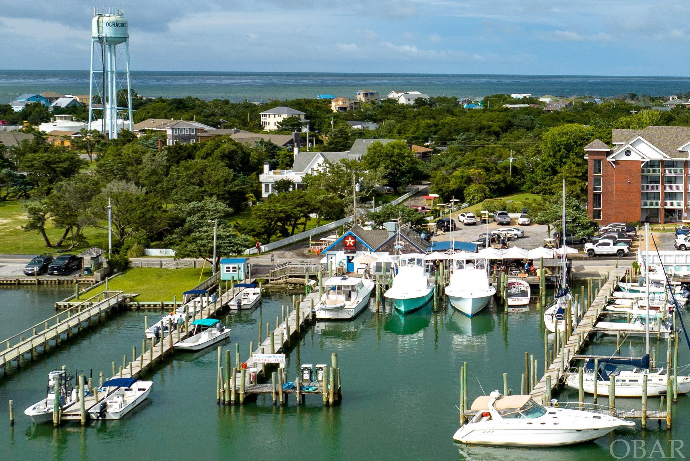 The only fuel service marina in Ocracoke is an international destination for transient vessels sailing the East Coast and ICW. 21 boat slips across 3 piers. Diesel and gasoline service center for dockside fueling. Power and water supply for overnight transient dockage. Marina is regularly fully booked throughout the season and there is a lengthy waiting list for long term slip leases. 150'+/- of prime harbor frontage right on Hwy 12. The Anchorage Marina and SmacNally's dockside bar and grill are the first commercial sitings off of the southern vehicle and passenger ferry. SmacNally's bar and grill, current restaurant lessee at the marina, is the only waterside dining on the island. Multiple slips occupied by local charter fishing boats, a large afternoon attraction. Turnkey opportunity for an owner/operator or investor wishing to own a long standing and successful island business. Package deal available for combined purchase of Ocracoke Marina and Anchorage Inn. Contact your agent today for more details.