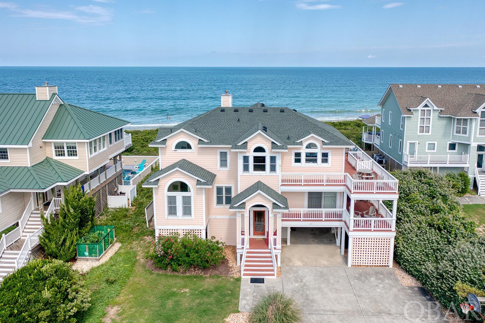 Location WOW factor!  This Duck ocean front is South of the pier with a mature, stable and massive protective dune.  No beach nourishments have been needed for this section of the coastline.  Located near and between the town of Duck and the "Avenues" of Rt 12, the location is ideal and highly sought after!  The community will impress and so will the home!  The cul-de-sac location adds to the privacy of the street only servicing this community.  The ROI with approximately $240,000 rental income for 2023 is impressive and has more growth opportunity with your personal touches.  Close quickly and reap the significant income remaining for this season (at time of Listing $111,700) for an immediate return on your investment!  Beautifully landscaped with a huge oceanside pool, dune-top deck overlooking the beach and a hot tub makes for "choices, choices, choices," on where to relax next.  Enjoy nature with your morning coffee watching dolphins, pelicans and even deer!  When taking pictures, we saw a fawn and her mother in the dune thicket enjoying lunch and providing a little landscaping assistance (see pic #8).  The mature dune and solid pool fence have prevented sand drifting into the pool area which is a on-going maintenance problem with some other homes.  Expansive sun and covered decks with views, views views!  Every bedroom exits to a deck or patio.  The ocean views from inside the house are expansive.  You must see this home to imagine all the possibilities.