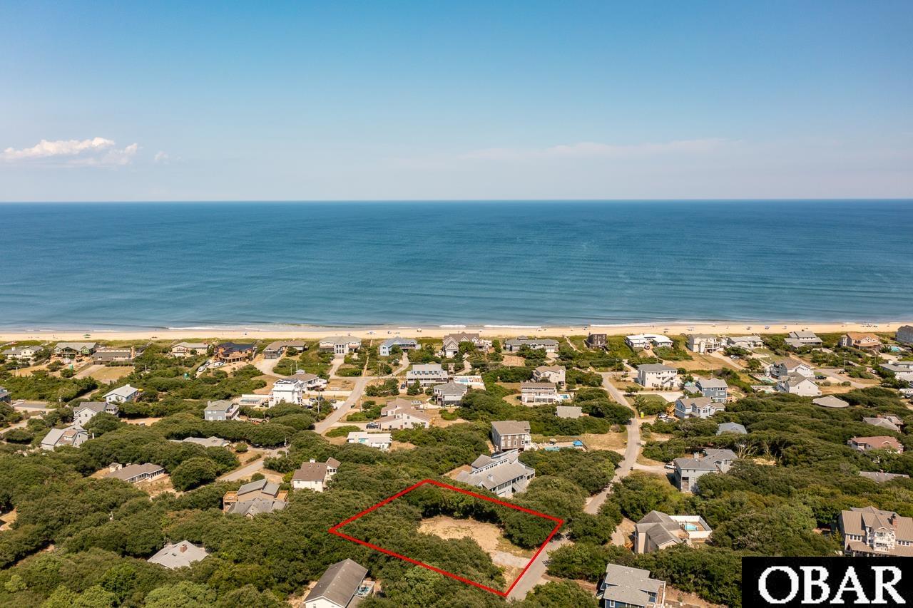You don’t want to miss this rare opportunity to build your dream home on the highest elevation street in all of Oceanside Southern Shores. Fourth Avenue is a picturesque cul-de-sac with private ocean access just 100 yards away from this lot. This locale is just one you cannot recreate, especially with the land prepared for you in advance. Your spacious floorplan (3500 sq. ft+) and outdoor living space with pool awaits. See potential house plan in associated docs to get a feel. Compared to other single-family homes on the market in Duck and Southern Shores, you can build with high end finishes and appliances, and STILL be under most asking prices and have a BRAND NEW home. Town of Southern Shores allows for accessory dwelling to be built on the property as well, meaning you can build a mother-in-law suite, or a rental to bring in income. Situated on a large "X" flood zone lot with highest elevation on the street and measures just under a ½ acre. Being in an “X” flood zone, flood insurance is not required. Optional membership in the Southern Shores Civic Assoc. ($65/yr.) allows access to marinas, a sound-side beach, parks, and social activities. Tennis and Boat Club memberships are also available for a small annual fee. This property has been cleared, a small concrete pad (used for parking) remains, county water tap already in place, saving approximately $3,000 when a new home is built.