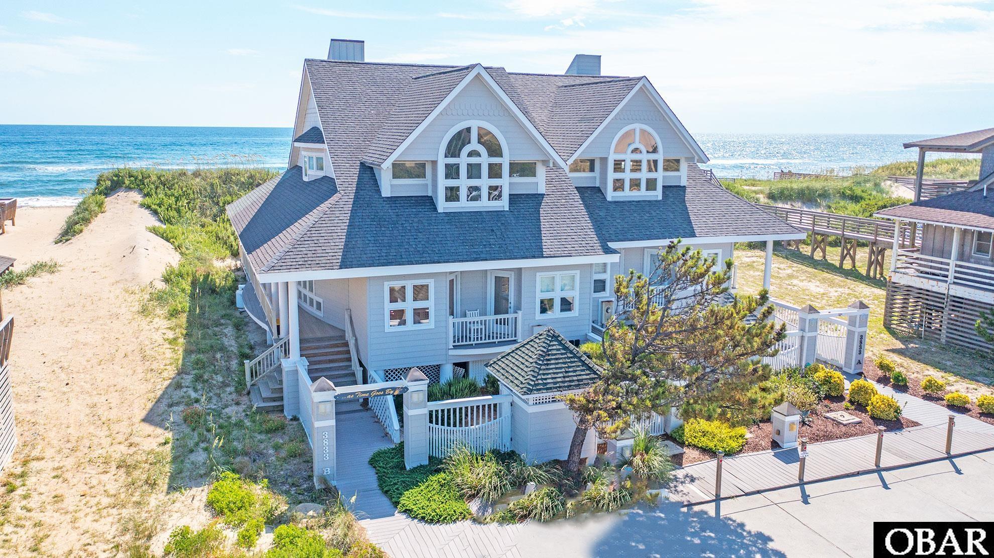 OCEANFRONT "2" UNIT CONDO DUPLEX - THIS IS THE NORTH UNIT B THAT IS FOR SALE ... ACROSS FROM JOCKEY'S RIDGE & SITUATED ON PRIME UNCROWDED SECTION OF THE BEACH ... THIS IS OCEANFRONT AT ITS BEST! This Home rents very well with Owner Income ranging in the $73,000yr range w/ current company. Sun Realty Projects 2024 Income $104,265 *** You will enter the home via the north Front Covered Porch to north side Main Entry Door ... Composite decking (easy on the feet and great for wear and tear), sunken Hot Tub on East Oceanfront Deck ... shared Walkway to Beach (this is a shared maintenance item with your neighbor who owns the other unit 3833A) ... this is a 2-unit Duplex Home on an 80-foot-wide Oceanfront Lot ... so you co-own the land with your neighbor, and you individually own your home. This includes a 1/2 interest in the platted 80 x 466 Oceanfront Lot upon which this home and the South attached unit are situated. *** Home needs some updates but priced accordingly. Home appears to have good bones and a great design - perfect for updating to make it fit your Lifestyle & Desires! *** Level 1 Features: Home Features Unique and Desirable Multi-Dimensional Window Display w/ Transoms which provide additional Natural Light ... You will feel like you are Outside at the Beach, and Experiencing the Warmth of the Sun, Gentle Ocean Breezes and waves breaking gently against the shore - All the while in the Quiet of this Beautiful Home! The Spacious Great Room (East - Oceanfront side of the Home) also Features High Ceilings * This Level also Features a Cozy Kitchen & Table Space area * There are 2 Bedrooms and a Hall Full Bath in the west wing of the home - you will love the Cozy Porches off the Bedrooms. (NOTE: Wood fireplace is non-functioning - best approach here is to replace it with a new gas fireplace insert) *** Level 2 Features 2 "Very Large" Ensuite Bedrooms with Huge spaces ... Tiled Showers, Japanese Soaking Tub in the East Oceanfront Bedroom and a Jet Tub in the West Ensuite Bedroom with a Huge Window Overlooking Jockey's Ridge * The East Oceanfront Bedroom Features Ocean Surf on Beach VIEWS FROM BED! * Door to Fiberglass Oceanfront Deck w/ absolutely Stunning Ocean Views ... the Sunrises are something to behold in Life! It just doesn't get any better than this ... other than the Sunsets! Here is an excerpt of the Carolina Shores Rental Ad: "A gracious oceanfront home with all the perks you expect. At As Time Goes By you can pamper yourself in the Japanese soaking tub or relax the hours away in the hot tub. This beautiful home features four bedrooms (two of which are MAIN ENSUITES), wet bar, private dressing areas, window seats and even original artwork. There is even a wine refrigerator. You will find As Time Goes By to be both contemporary and stylish! New Living Room Furniture for 2017! PROPERTY BEDDING: 1 KING, 2 QUEENS, 2 TWINS. TOP LEVEL: Master with King and Bath with a Japanese Soaking Tub, Master with Queen and Bath with a Jacuzzi Tub, GROUND LEVEL: Kitchen, Dining Area, Living Area, Bedroom with Queen, Full Hall Bathroom, Bedroom with Twins." *** Here is a Renter Review from 6-20-23 by Melissa O. from Williamsport, PA rated 5 of 5 for CLEANLINESS, LOCATION, PROPERTY CONDITION ... "Wonderful! We loved our stay at this home! The upstairs rooms are beautiful and lots of space! Downstairs bathroom was small for a shared bathroom, but we made it work. You couldn't ask for a better beach access. We enjoyed that VERY much!" "This home was perfect for our family, and we will be returning!" This is a "2 Unit" Condo ... Condo Docs Available to review *** Owners Rents 2021 @ $68,388, 2022 @ $72,785 and YTD 2023 @ 60,039 as of 7-25-23 * Sun Realty 2024 Projection @ $104,265 * Furnished (some exclusions) and Ready for you to collect Rental Income, Entertain Family & Friends, or just enjoy all to yourself! ... This Oceanfront Home is Unique and Amazing and Has Great Vibes ... and a Fabulous Location ... Come See! ... You'll Love i