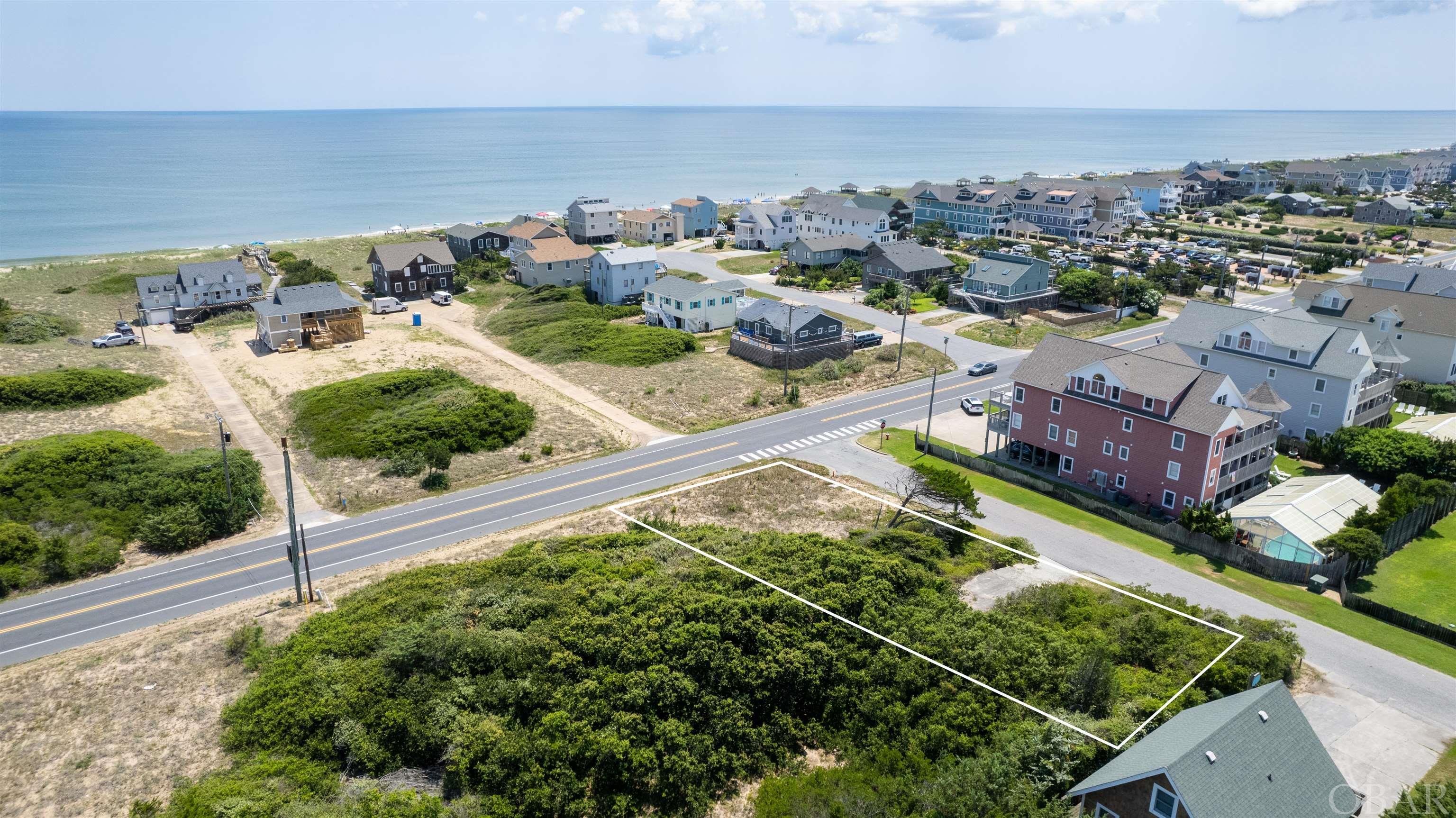 Location, location!  Located in an X flood zone, this coveted corner lot is nestled in the heart of Kill Devil Hills and offers location value and close proximity to the ocean.  Build your dream home or investment property and enjoy all the OBX offers.  Per the town of KDH, the water hook-up fee has been paid.  Survey in associated documents.