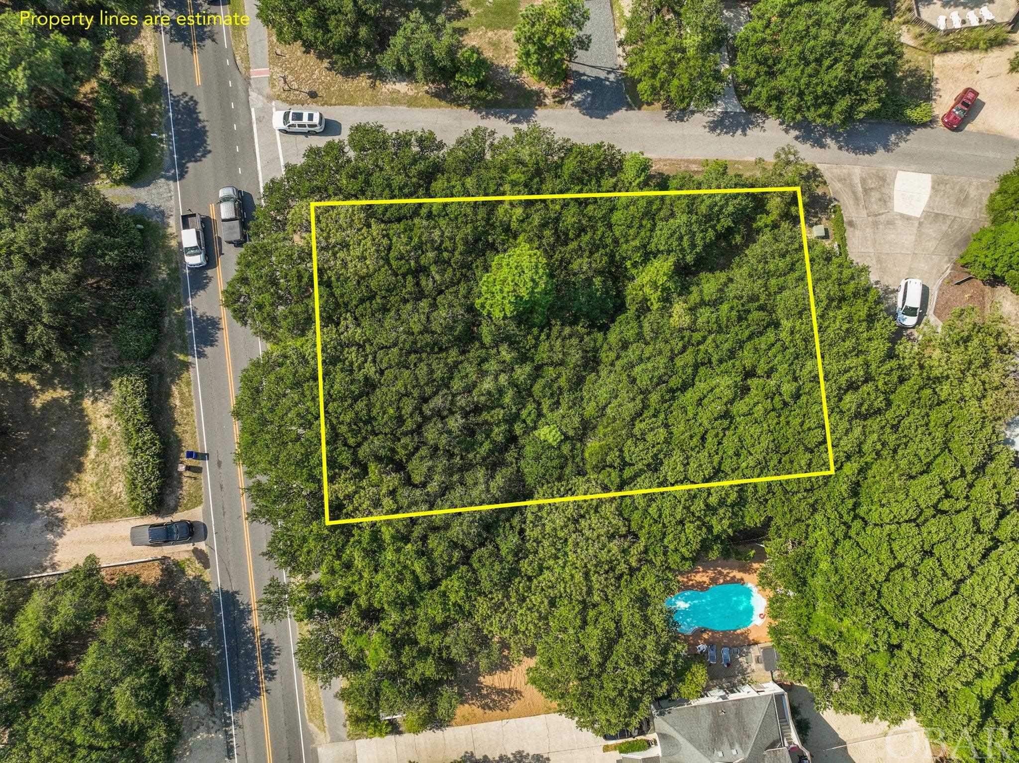 This wooded lot in Southern Shores offers a prime location with a quick and convenient walk to the nearby beach access point situated at the end of the block, accessible straight down 7th Avenue. Additionally, its strategic placement places it just two blocks away from the Hickory Street traffic light, making it easy to connect to Duck Road, a key route in the area. This parcel is ideal for realizing your vision of a custom dream home or a vacation rental property. Being situated in an X flood zone, you'll benefit from not having to pay for flood insurance costs, making it a financially appealing choice. Whether you're looking to create your personal haven or an income-generating rental, this lot's characteristics make it well-suited for either endeavor.  Ocean views are possible. For those looking to enhance their coastal lifestyle, an optional membership to the Southern Shores Civic Association (SSCA) is available. This membership offers various privileges such as access to a marina, a serene sound-side beach area, parks, and additional amenities. This adds an extra layer of appeal and value to the property, providing opportunities for recreation and relaxation. Given its scarcity, this lot is a rare gem within the sought-after Southern Shores community. With its strategic location, proximity to the beach, and potential for constructing your dream home or investment property, it presents a unique opportunity for those seeking a slice of coastal paradise within this highly desirable neighborhood.