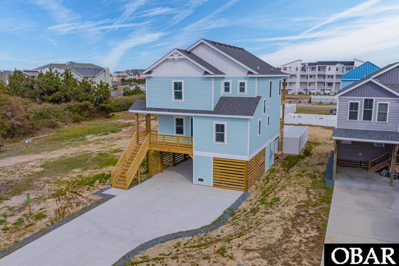 Discover modern luxury and embrace the coastal charm of this brand new 4-bedroom, 4.5-bath beach house. Located in the heart of Kill Devil Hills, this home is a testament to architectural excellence with beach access! This means you can relish early morning walks on the sandy shores or unwind with lazy afternoons by the sea. Boasting an open-concept living space filled with natural light, it seamlessly connects to a gourmet kitchen featuring top-of-the-line appliances and exquisite finishes. Each of the four bedrooms offers a private retreat, complete with en-suite baths for ultimate comfort and privacy. The home's design is optimized for relaxation and convenience, featuring an elevator and a heated salt water pool that enhance its appeal as a potential rental and investment property. Whether you're seeking a permanent residence or a vacation getaway, this home captures the essence of coastal living. Immerse yourself in the tranquil ambiance of Kill Devil Hills, where the beach and local attractions are within easy reach. Don't miss this chance to own a slice of coastal paradise that offers not only a comfortable lifestyle but also a promising investment opportunity. Contact us now to experience luxurious seaside living at its finest!