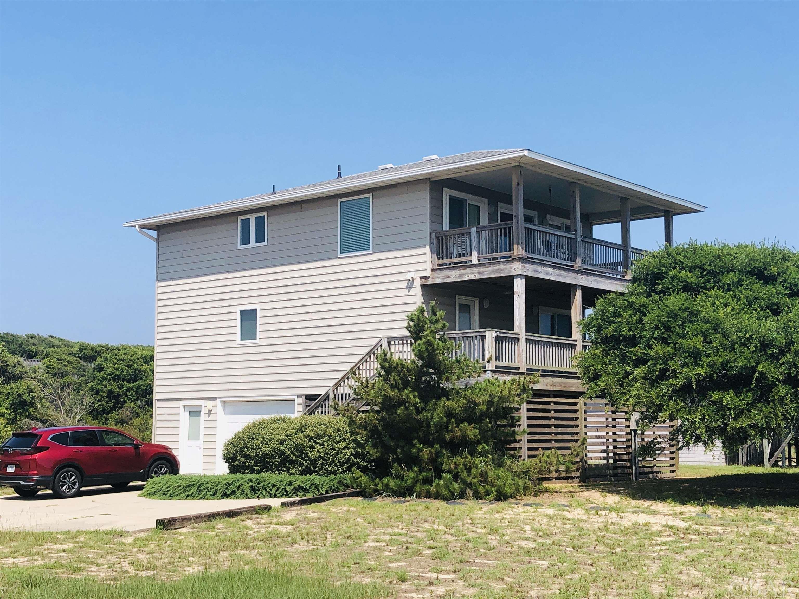 Okay Folks - Here is your chance to own a Move-in-Ready Well-Cared for Home in Oceanside Kitty Hawk with Direct Access to the Beach down Luke St (about 400 feet from the Beach Access). Comes with Million Dollar, Forever Unobstructed Panoramic Water Views down Luke Street. Less through traffic since part of Luke Street is one-way. The Home was renovated and had the back wing of the house expanded from the ground up with 390 SF of heated living space 2017, which was taken down to the studs, with the following List of Updates: Hydraulic Elevator to all floors; New Kitchen with Gorgeous Granite counters, Ceiling height White painted Wood Soft Close Cabinets & Doors, Subway Tile Backsplash and new appliances; Enlarged the upper Master Bedroom and added a Walk-in Closet and a Beautiful Ensuite with a Walk-in Shower; Large Walk-in Closets in the two rear Bedrooms on the middle floor; New 30 year Architectural Roof; New Gutters;  New Windows, Sliders and Window Treatments; New HVAC units inside and out; New Septic System; New Plumbing & Water Lines throughout; Deck renovations with roof extension to create a covered Deck; New Flooring throughout; Rocker Panel light switches & Lever Door Handles Installed throughout; Many new fixtures throughout (ceiling fans, bathroom vanities, toilets, mirrors, towel bars, medicine cabinets & faucets); Has a Large Storage Room on the ground floor; plus added an Oversized 1 Car Garage with an automatic Garage door opener which creates a Dry Entrance. Second Floor Bathroom remodeled 2021. Water Heater replaced 12/22. Three Spacious Bedrooms on the middle Floor with a Full Hall Bathroom with Tub shared with the east Bedroom, plus the Laundry is located on this level with full-sized Washer & Dryer. Upper Level has Incredible Ocean Views, an Open Floor Plan with Sliders going out to a covered Deck, a Half Bath, a Beautiful Fully renovated modern Kitchen, and a Large Bedroom w/Ensuite and 3 Large Closets. Large 15,000 SF Lot should accommodate a 12' by 24' pool. So close to the Beach yet located in a No Flood "X" Zone. Used a primary home for over 20 years.