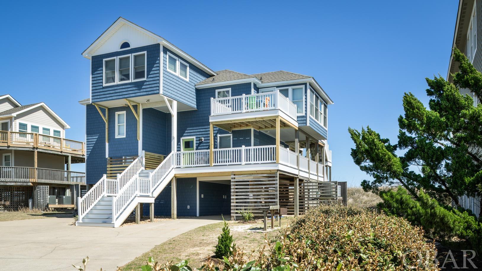 Looking for a great home on an amazing oceanfront lot, this is it.  Located in Carolina Dunes, this 75ft wide x approximately 300 foot deep oceanfront lot has beautiful views of the ocean and the beach.  Located in one of the most sought after areas of the OBX, the lots are large and the elevation is high.  There aren't many oceanfront homes where you can actually see folks enjoying the beach from the house.  Six bedrooms and all on on the 2nd or 3rd floor.  All rooms enjoy plenty of natural light and 4 with direct access to the covered or sun deck, hot tub and magnificent views of the ocean.  The owners have constantly updated this home.  Within the past 5 years, the siding has been replaced with vinyl shakes rated at 200mph, all new trek decking with vinyl white vinyl railings.  Inside, they have added white shiplap ceilings to many of the rooms, upgraded the flooring with LVP and remolded all 4 baths with flooring, 3 tile showers, all new vanities and fixtures.  Many windows and doors have also been replaced to new higher quality glass.  Enjoy sitting on the polywood furniture on the sun decks or relaxing in the new hot tub on the covered deck while watching the happiness on the beach.  You can move right in as this one has been lovingly cared for and maintained.  You don't want to miss this one.  If location is everything for you, you should see this one today!