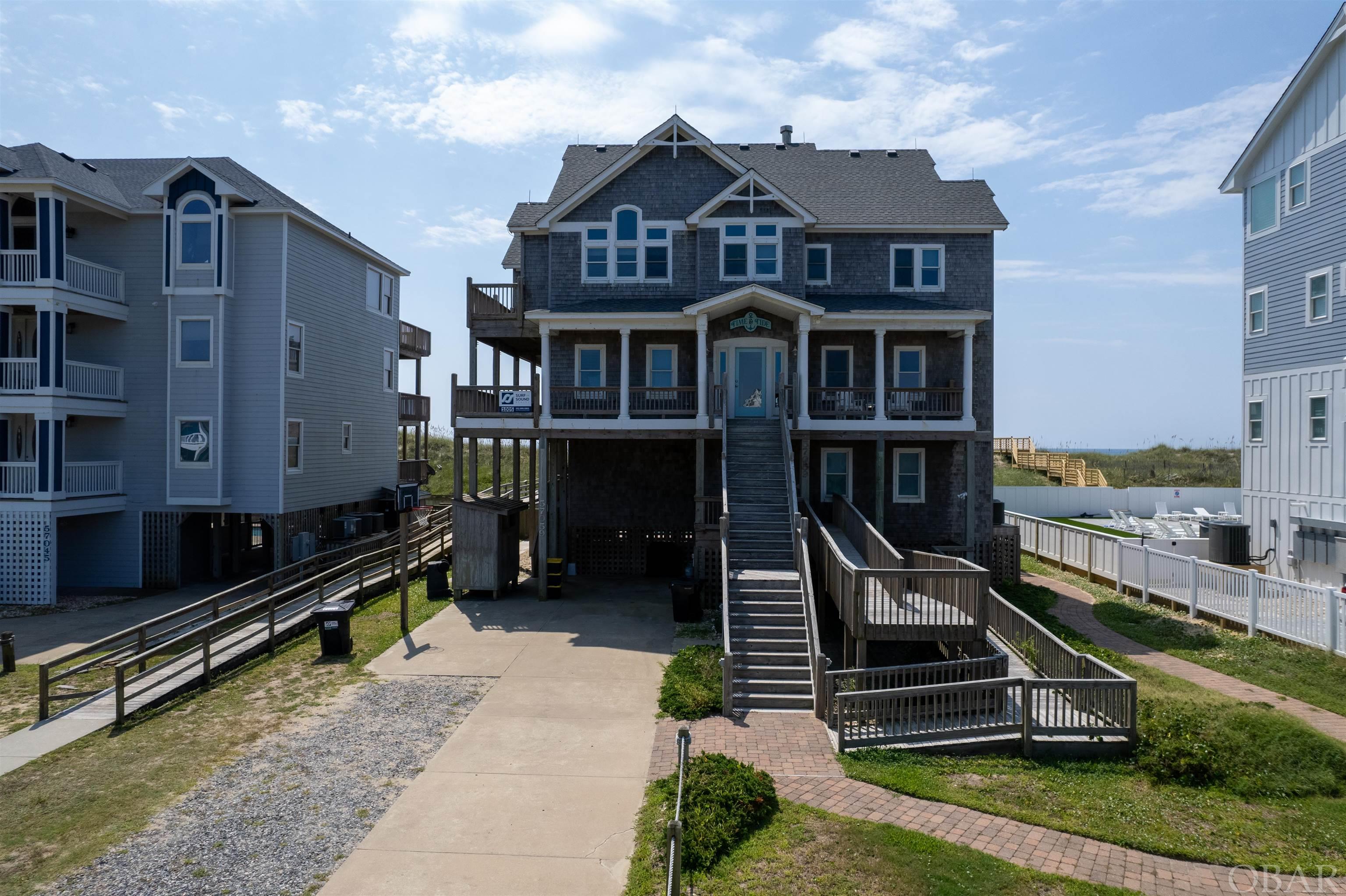 HATTERAS VILLAGE, QUINTESSENTIAL OUTER BANKS. Make your beach dream come true with this beautiful oceanfront home, appropriately named TIME AND TIDE. Whether a personal family vacation retreat, or an investment property with excellent rental income, this gorgeous home will satisfy your search. Floor-to-ceiling windows give a 180 degree ocean view. Vaulted ceilings and hardwood floors open the space for group gatherings. 6 bedrooms are en-suite (2 with jetted tub), with a 7th room being used for another bedroom. The upper level great room features a chef's dream kitchen, wood-burning fireplace, elevator, reading nook...and those BREATHTAKING VIEWS. Additional features are a handicap ramp with one designated handicap bedroom, dry entry, large decks on every level, hot tub, game room with wet bar and two laundry areas. The private heated pool enjoys a nice wide apron, with pergola seating area. Quality outdoor furniture is plentiful around the pool and on the many decks...all, just steps to the waters edge. Make TIME AND TIDE slow down while you relax and enjoy the sunrise in your beach dream come true.