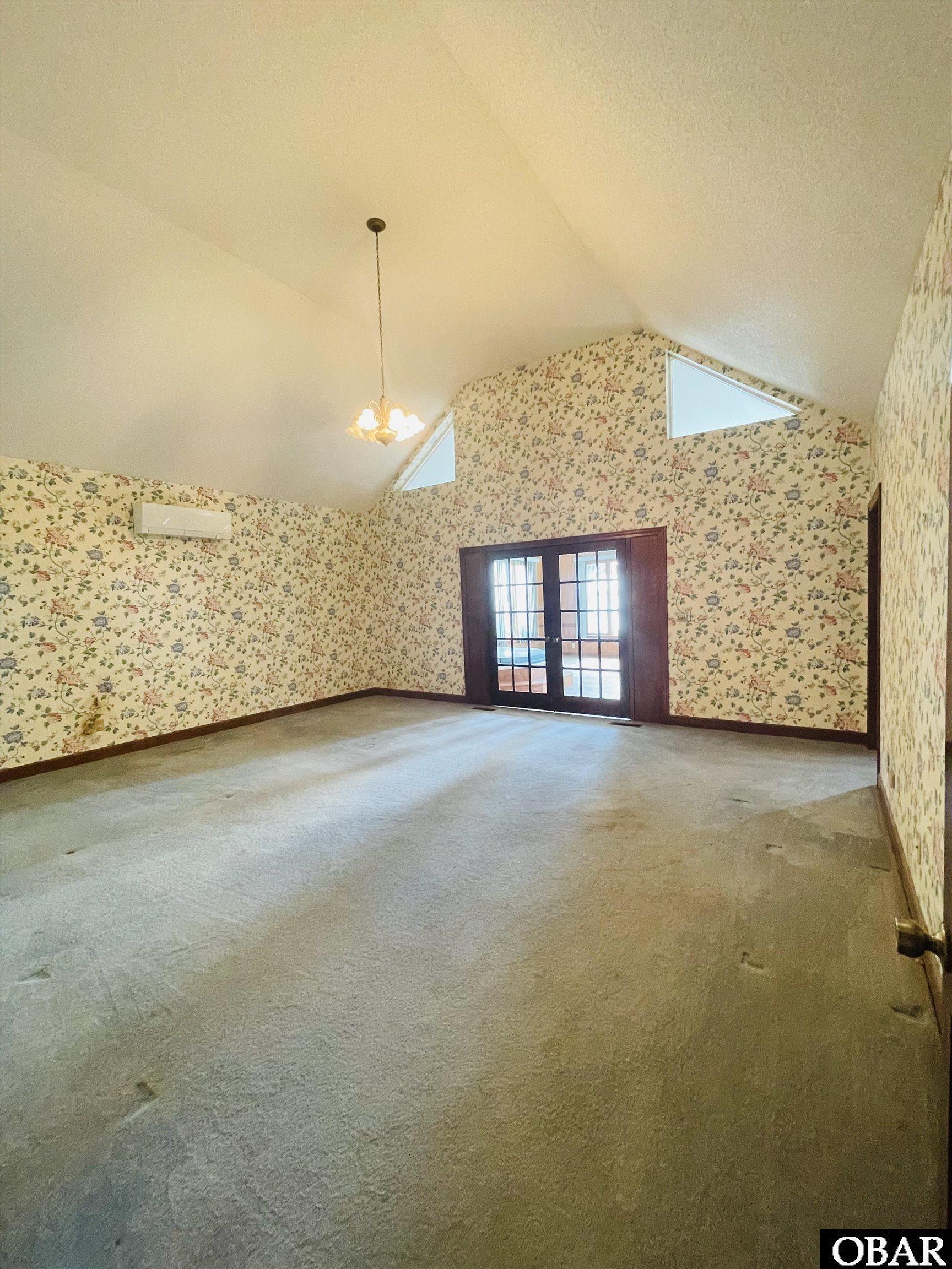 With full bath, closets, cathedral ceiling, and French doors that lead to the Sunroom/Hot Tub/Bar off deck!