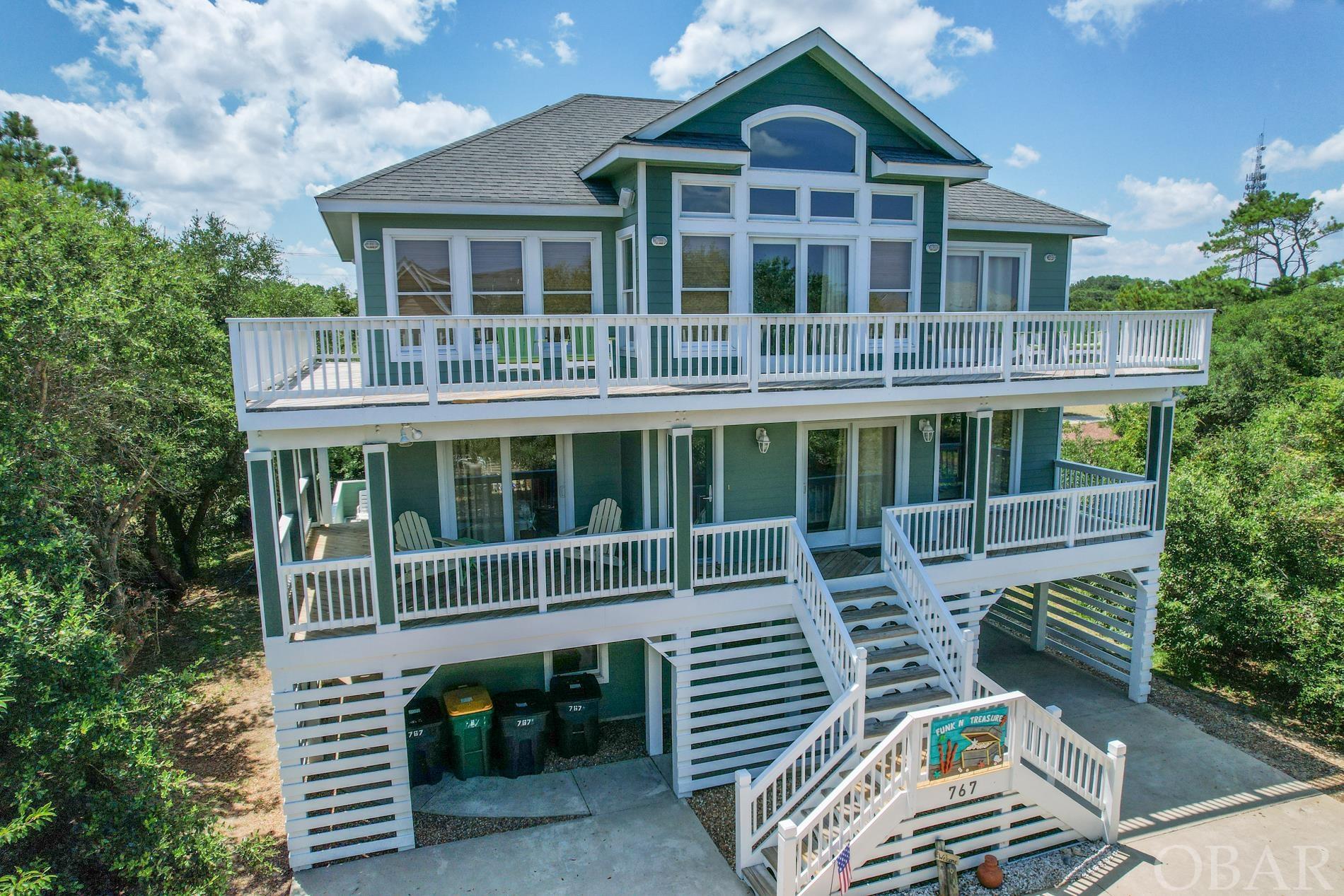 Nestled away on a cul-de-sac with an extremely thought out floor plan, this 3 story coastal vacation home is a rental powerhouse! Located on the ocean side of Route 12 in the Ocean Sands subdivision, it's only 3 blocks/.3 mile/6 mins from ocean access. This beauty sleeps 19! Top 3rd floor offers open concept great room (kitchen, dining and living areas) with cathedral ceilings. Lots of windows and 2 sliding glass doors to the 3rd floor sun deck which provides lots of light. Newer Lovesac furniture, large dining room table and a fully equipped kitchen including 2 dishwashers, 2 refrigerators, deep freezer, beverage fridge, pantry and FREIGHT LIFT which guests love. Also on 3rd floor, a half bath and primary bedroom w/ king bed, private sun deck access and ensuite bathroom. The 3rd floor primary ensuite bathroom has double vanity, soaking tub and full size shower. On the 2nd floor, there are 3 additional bedrooms with king beds and ensuites all of which have sliding glass doors providing access to 2nd floor covered deck. Also on 2nd floor, a 4th bedroom with a pyramid bunkbed, full sized hall bath and a flex space which is currently used as another bedroom with a queen bed. On ground level 1st floor you'll find a game room with pool table, wet bar, entertainment area, another 2 bedrooms (one with a queen bed and other with double bunk beds), a full size bath and laundry closet. Just outside the sliding glass doors of game room, you see a heated pool, hot tub, lounge chairs, gas grill, outdoor shower and owners storage. Back patio is fully enclosed and has the best of both worlds - partial sun and shade throughout entire day. Out front, a private basketball hoop in an oversized driveway fits up to 10 full size vehicles. Community bike path is just outside the neighborhood; the homes location makes for easy access to shopping and restaurants. Renters return to this home again and again; no wonder it had over $99K on the books for 2021, almost $66K for 2022, $68K for 2023 and already booked over $61K for upcoming 2024 season. Whether a private vacation home for yourself or continued investment rental, you definitely don’t want to miss out on this one!