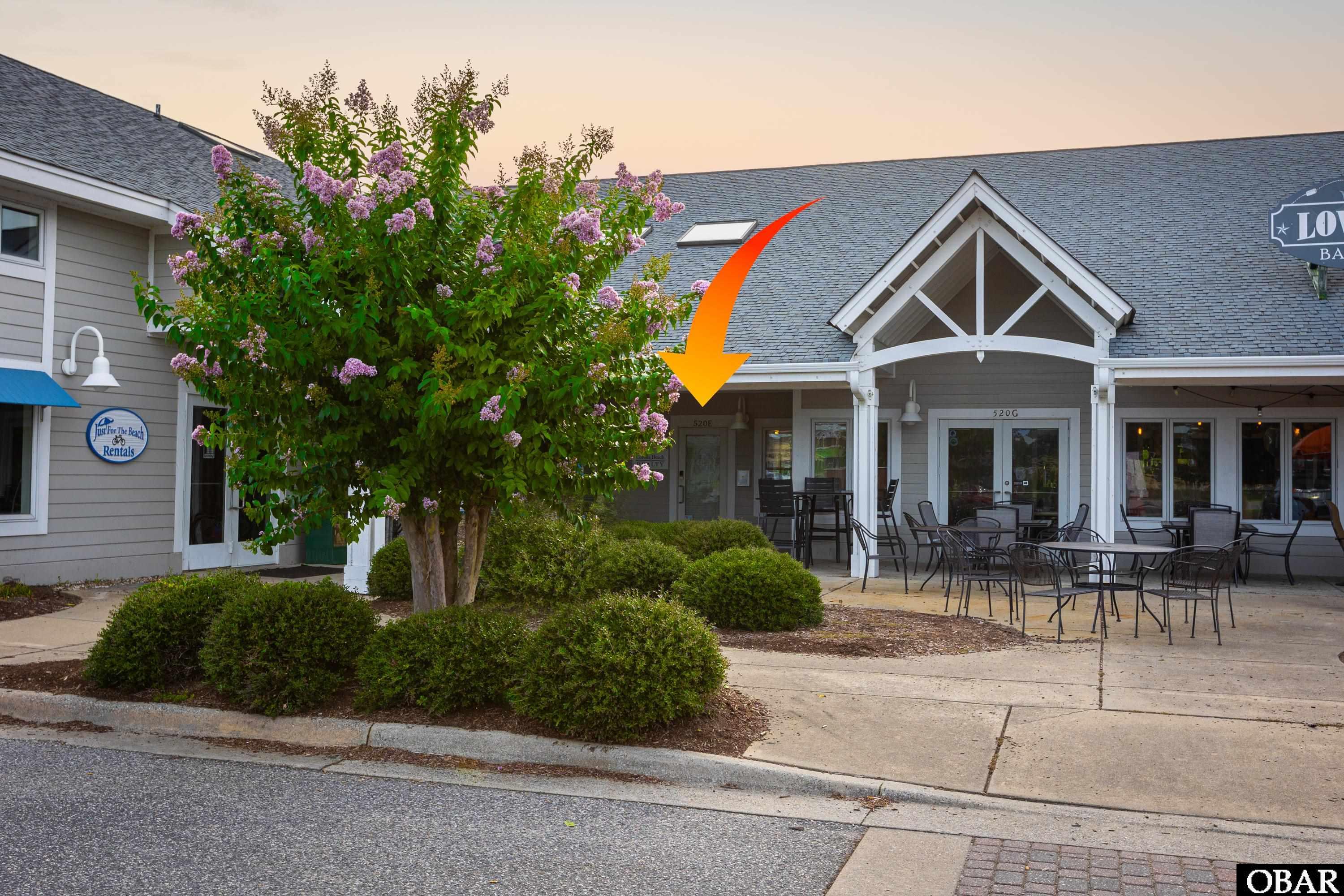 Perfect Opportunity to own your own office, or customize the space to fulfill your needs. Office, Retail, and Restaurant options are a few of the many possibilities for this 800 Sq Ft commercial condo located in the highly sought after busy vacation destination of Corolla.  Situated conveniently at the South entrance to The Currituck Club, near restaurants, shopping, Currituck Visitor Center, golf, tennis courts, and across the street from the public beach access.  This prime commercial space offers great visibility and frontage with large windows for prospective clients/customers to see your offering. Upon entering, you step into the foyer with a sitting area and reception counter, which opens to the main area with 2 desks (currently). Additionally, there are 2 private offices that are well appointed on the left, a full kitchen, and a 1/2 bath bathroom. There is a large loft that can be utilized for storage which spans the length of the left side of the building, a generous storage closet, cabinets in the kitchen, and storage shelves in the bathroom. Furniture is negotiable. If you are tired of paying rent, or looking to invest in commercial real estate to begin your business and operate in your own commercial condo, then make an appointment to see this rare commercial opportunity in Corolla.