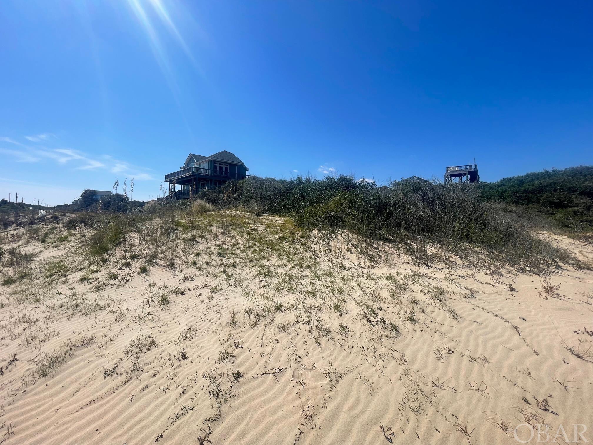 What a location!  This corner lot semi-oceanfront has GREAT elevation and DIRECT beach access.  Very few lots like this are left.  Located in the x flood zone, a future home here will have great preserved ocean views and one of the easiest walks to the beach!  Whether for a second home or a successful vacation rental, this lot is worth a serious look.