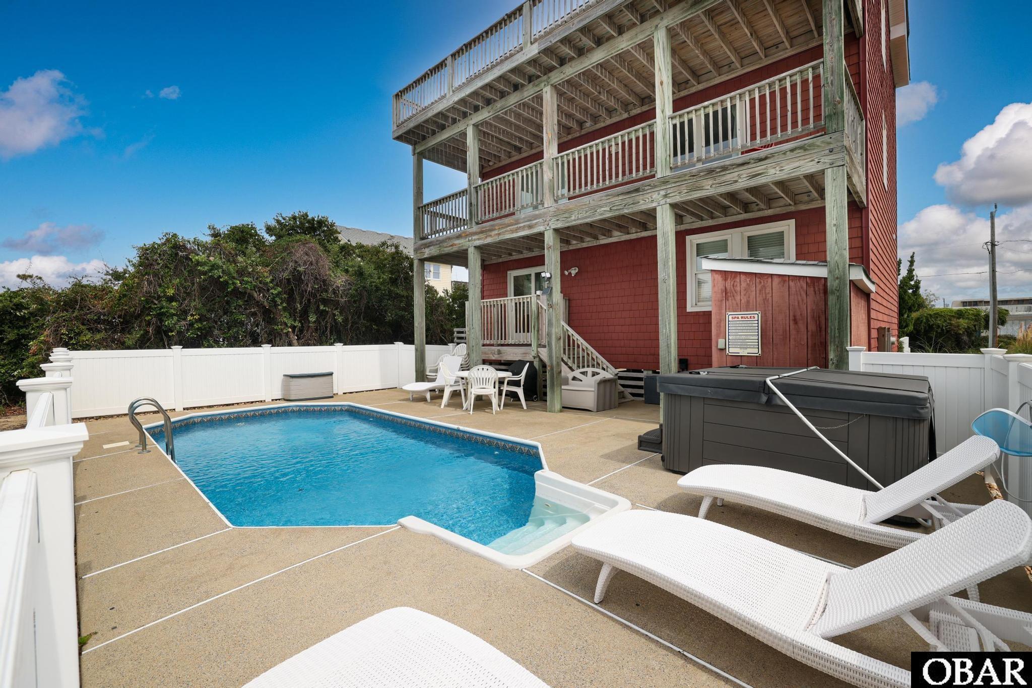 Welcome to your dream coastal retreat! This magnificent 5-bedroom, 3.5-bath home offers the perfect blend of luxury, comfort, and convenience. Nestled in the heart of the Outer Banks, it's an easy stroll to the beach, making it the ultimate beach lover's paradise. You'll not only love the proximity to the beach, but will also enjoy a short walk to many favorite restaurants, pharmacies, and even the new Starbucks! Inside, you'll find a vibrant color scheme, spacious rooms, and ocean views from the top level. Don't miss enjoying the ocean breeze from the front deck or relaxing in the hot tub year round. There is also ample parking with a double driveway. The home has been lovingly used as a second home for family and friends but has potential to be a rental machine - ask your realtor to see the uploaded rental projection! Don't miss out on this opportunity to own a slice of coastal paradise. Whether you're seeking a primary residence or a vacation home, this property has it all.
