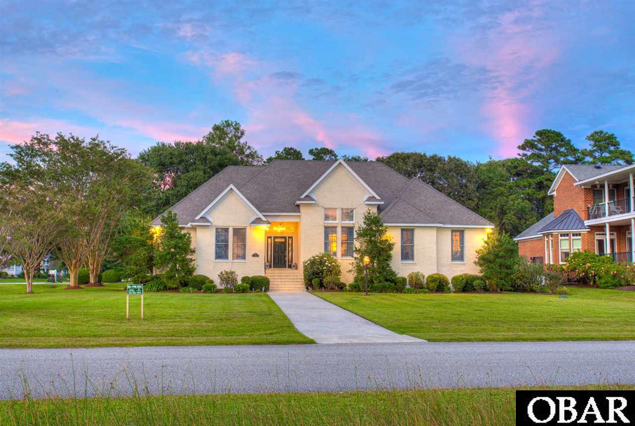 Looking for the ultimate peaceful haven? Look no further than this coastal masterpiece. Gently used as a 2nd home since 2006, until sellers made their primary residence in 2015. Elegantly appointed and remarkably built through and through, and above industry construction measures. Adorned by an abundance of custom finishes with sophisticated simplicity, the backdrop of the Heritage Point Marina and sound are center stage imploring a sense of relaxation the moment you cross the threshold. From the Grand Foyer you will immediately be captivated by the tray ceilings, crown molding, glistening hardwood floors, and the 14 ft dining room ceiling. Every feature thoughtfully considered and strikingly appointed. The freshly renovated chef's kitchen (Completed By Cozy Kitchens) offers Cambria Brittanica Gold silestone quartz countertops, quartz backsplash, new stainless steel Kitchenaid appliances, including an induction cooktop, eat-in bar, prep sink, center island, a pantry, and lots of cabinetry for all your storage needs. The gracious floor plan is brilliant offering a truly timeless flow between rooms with one-level living. There are  4 bedrooms (3 are master ensuites), and 4th bedroom could be used as a study/office with a full hall bath. This open concept offers a great room with custom buit-in cabinets, gas fireplace, dining room, eat-in kitchen with adjacent gathering space, pantry & laundry room, and sunroom. The main master is separate from the other master suites, boasting another custom tray ceiling, large walk-in closet, hardwood floors, a sumptuous bathroom with his & her vanities, and custom tile shower. The 2nd master suite is also grand high ceilings in the bath and bedroom, a sitting area and plenty of closet space. The 3rd master suite is just down the hall featuring another tray ceiling and private bath. The house has unprecedented amount of storage, attached 2 car garage, a generator, a well for the irrigation system (municipal water for home), and home alarm. The backyard offers a bird sanctuary with Cardinals and Blue Jays, adorned with gorgeous Camellia Bushes, Azaleas, Magnolia Trees, and more. Heritage point is a quiet residential boating community providing each lot owner with its own private boat slip, community soundfront beach, fishing pier, tennis courts, and clubhouse. Please copy and paste the following link for aerial video: https://www.youtube.com/watch?v=OGIfj8bRpEI