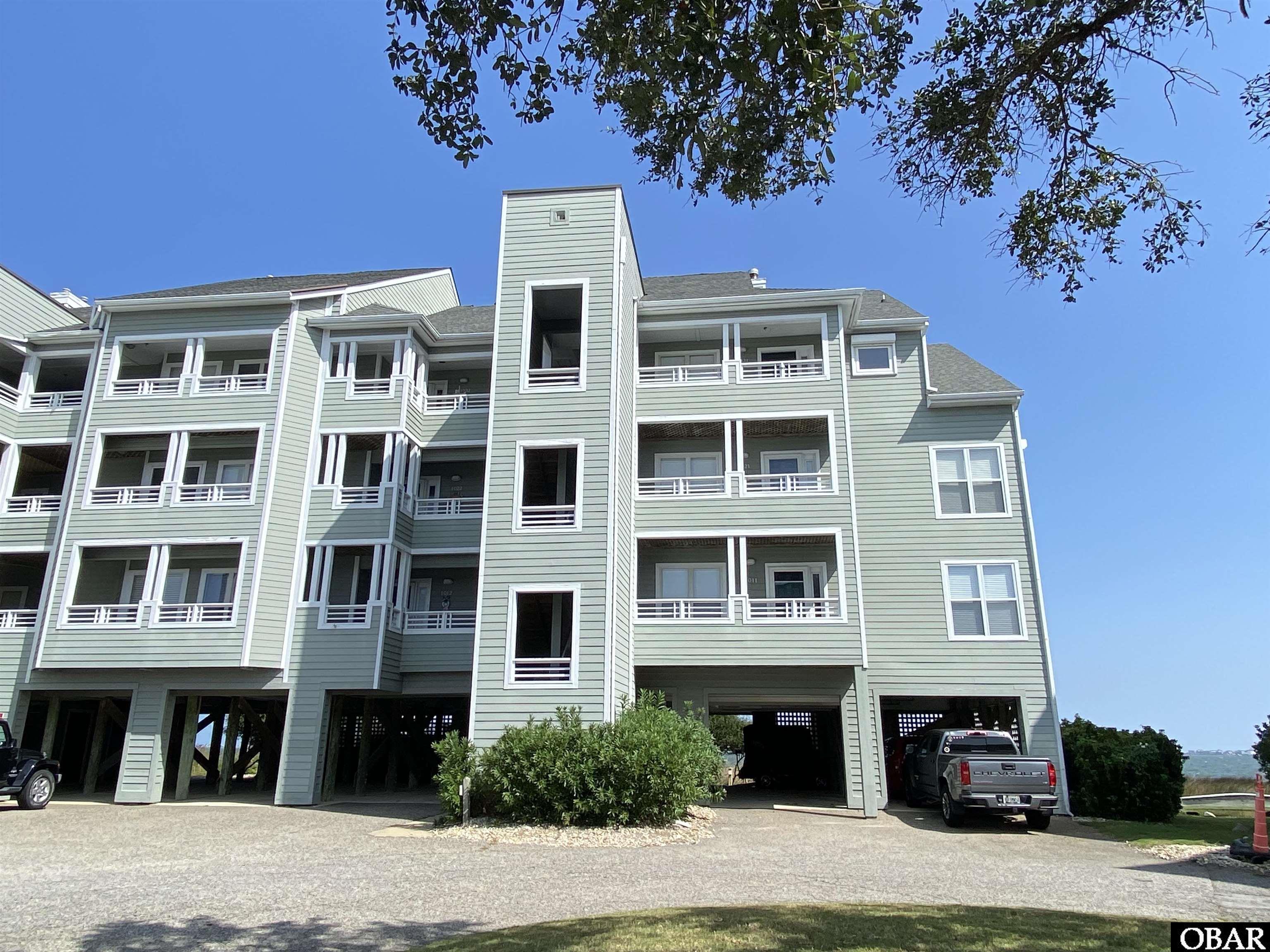 This bright and spacious top floor, end unit has views for days! Sold furnished, this 2 bedroom 2 bathroom condo has everything you and your guests will need. The open floor plan allows sound views from the living/diving area as well as the eat-on bar, throughout your kitchen & on the expansive covered balcony. Equipped with motorized hurricane shutters on remote, a brand new slider with hurricane wind rated glass to the sound front deck, double covered parking, elevator & 25' boat slip in Rudder canal, this place has it all whether you're purchasing as an investment or using as a second home! Owning here you will also enjoy all the fantastic amenities Pirate's Cove has to offer : 2 swimming pools, tennis courts, miles of dock for walking & fishing, fitness center, clubhouse, playground, world-class fishing marina, on-site restaurant & Tiki Bar.