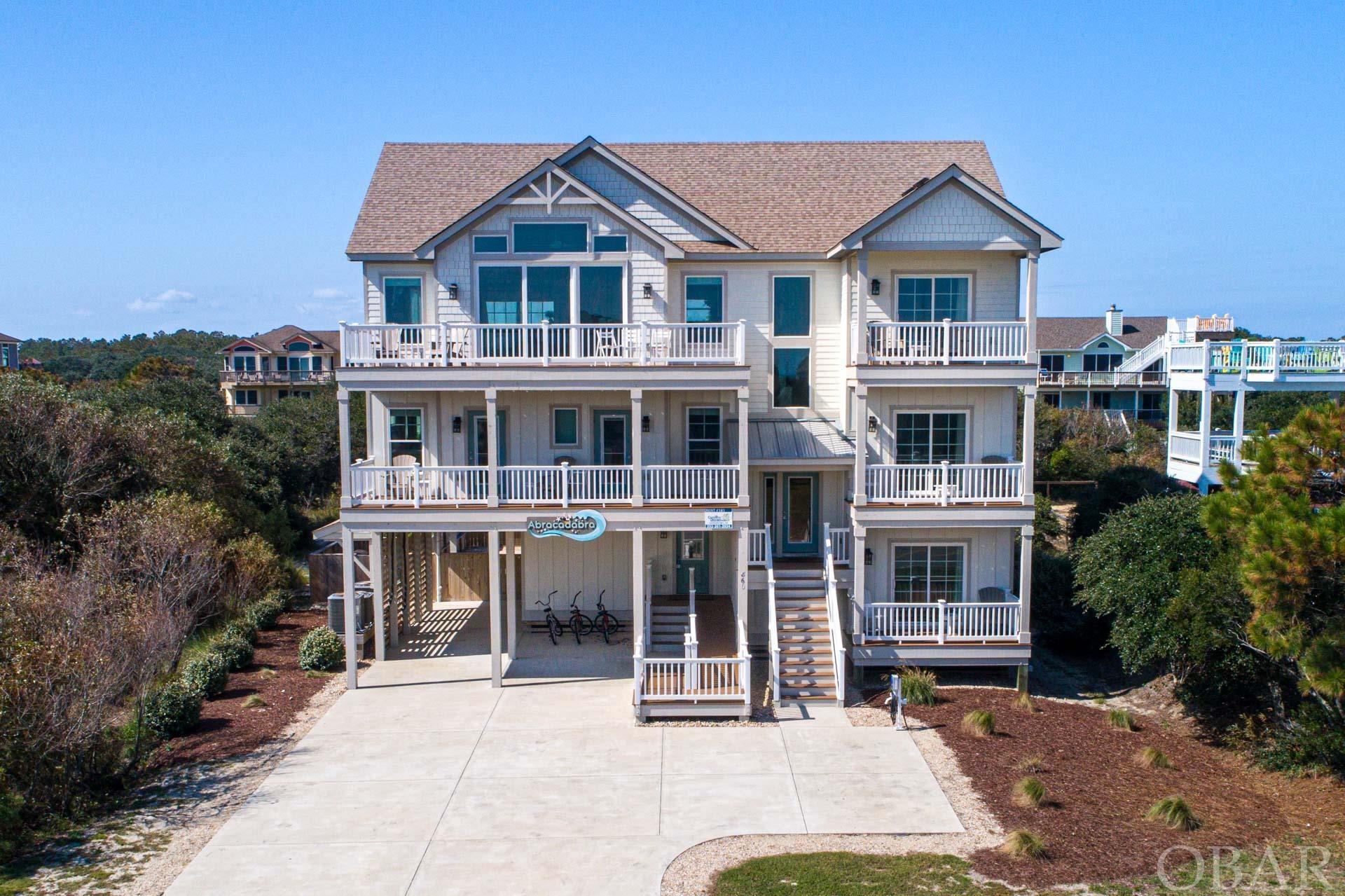 Nestled in the picturesque Whalehead community, this exquisite 10-bedroom home, completed in 2020, offers a harmonious blend of luxury and coastal living. Step inside and be greeted by a modern marvel with ocean views. A private elevator ensures easy access to every level of this sprawling coastal retreat, making it accessible for all. Entertainment takes center stage with a dedicated media room, perfect for family movie nights or watching your favorite sport. Your guests will be delighted by the spacious en suite bedrooms, ensuring comfort and privacy for all. The outdoor oasis is a true paradise boasting a concrete heated pool invites year-round relaxation, while the composite siding and Trex decking ensure durability and low maintenance. This home is in an X flood zone with no flood insurance required. This rental company provides an EV charger perfect for those with electric cars. Savor sunsets on the deck or take a short stroll to the beach for a dip in the Atlantic. Situated close to the iconic Corolla Lighthouse, you're also just moments away from shopping, restaurants, and the allure of the wild horses that roam freely in Carova just minutes away. This beach house is a lucrative investment opportunity, with incredible rental income!