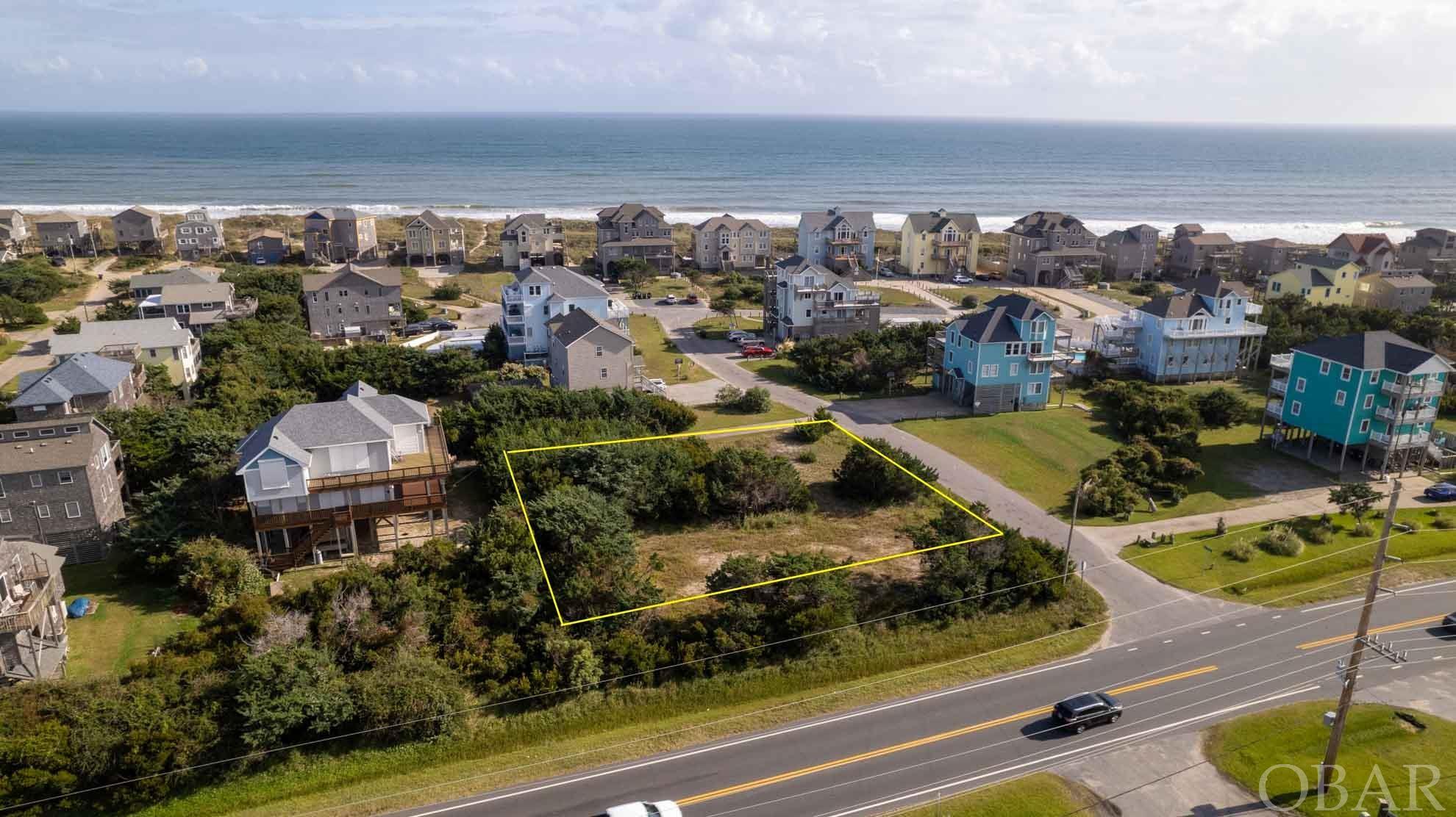 Third lot back from the oceanfront will have views of the ocean and the sound with quick and easy beach access. Note that some aerial photos were taken at 30 feet to show the probable view from your newly constructed beach home. It is a great lot in the Frisco beach area for a large home with driveway access on Tides Edge. Build what you want rather than trying to make do with an existing house in a market with very limited inventory. A 2022 Survey, soil testing, and subdivision covenants are available. Some selective lot clearing and loads of fill have been accomplished, leaving a nice buffer of trees for privacy. Tidesedge subdivision was established around 1999, requiring a minimum 1800 heated square feet. It's nicely paved roads and beautiful neighboring properties makes this one of Frisco's premier oceanside locations.